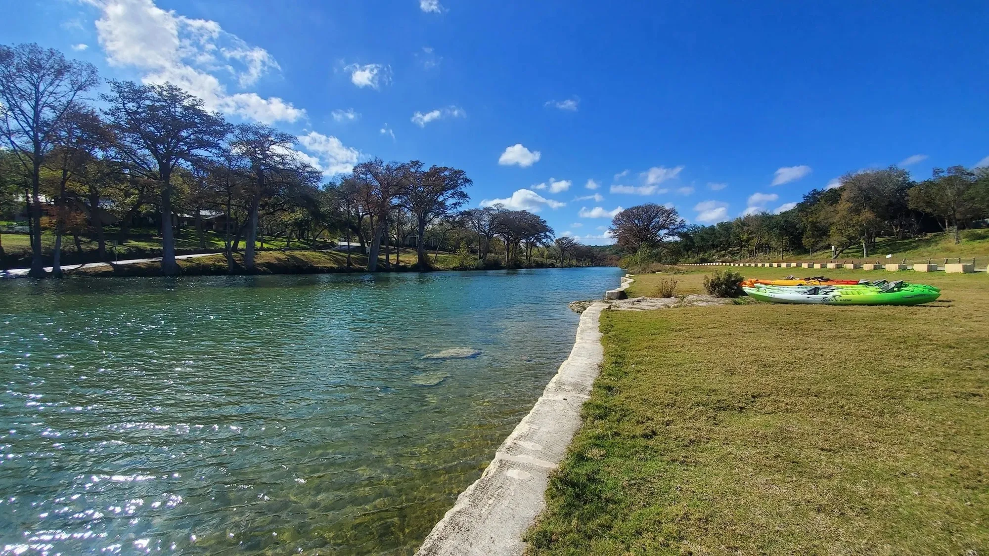 The Blanco River beside the lawn and kayaks at 7A Ranch
