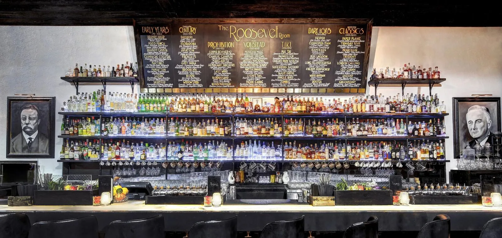 The Roosevelt Room's downstairs cocktail bar, with bottle-lined shelves and upholstered seating