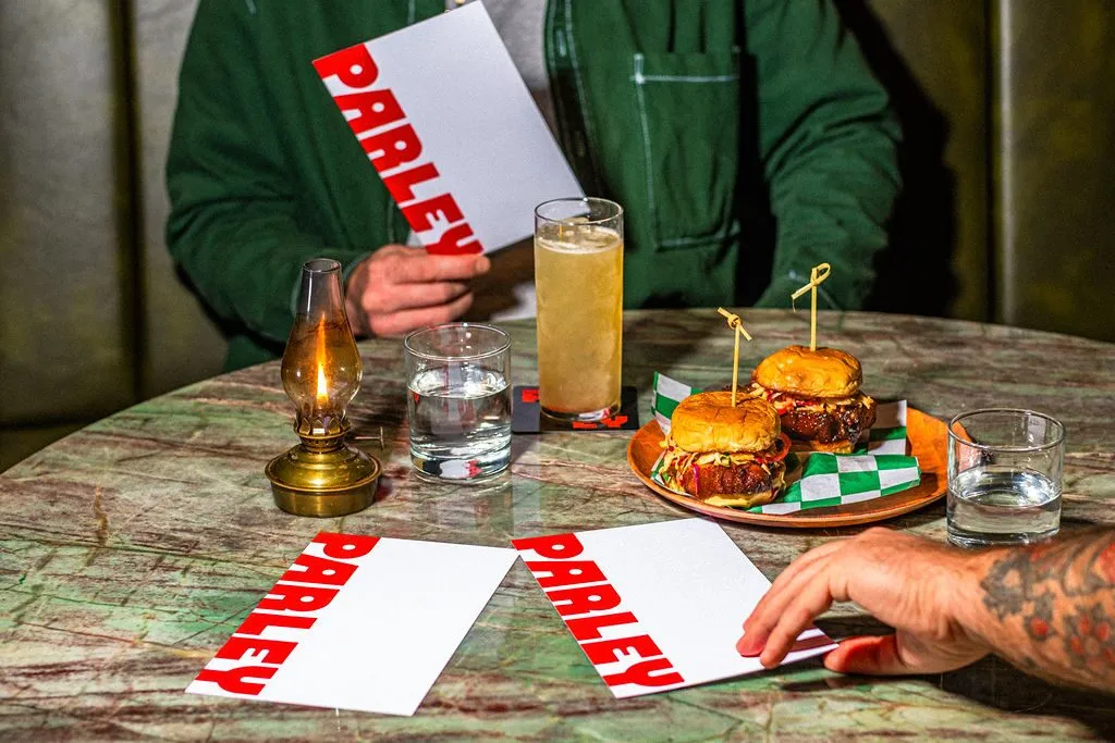 A burger and drinks arranged on a marbled table at Parley