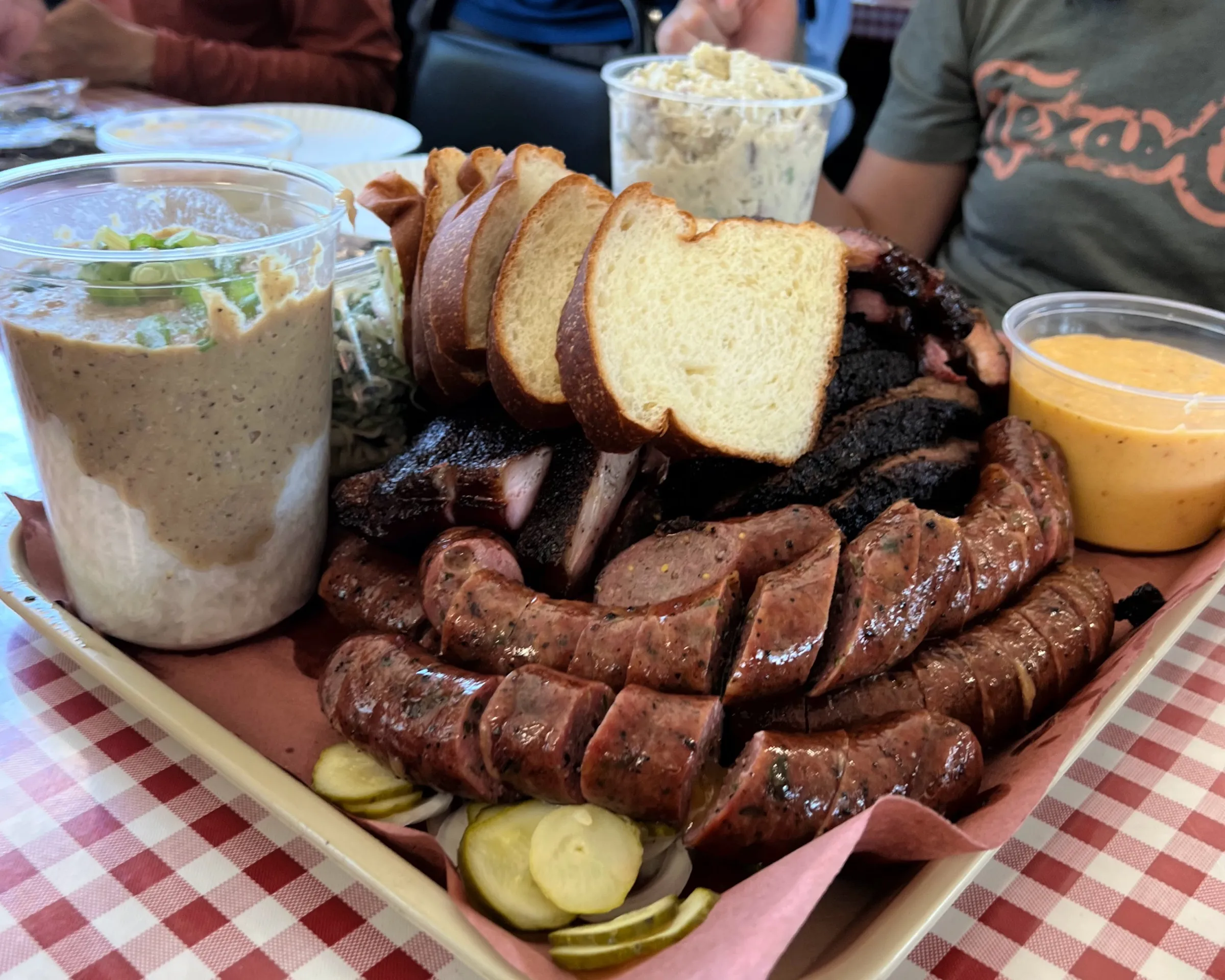 A tray of sliced brisket, pork ribs and sausage served on butcher paper at Goldee's Barbecue in Fort Worth
