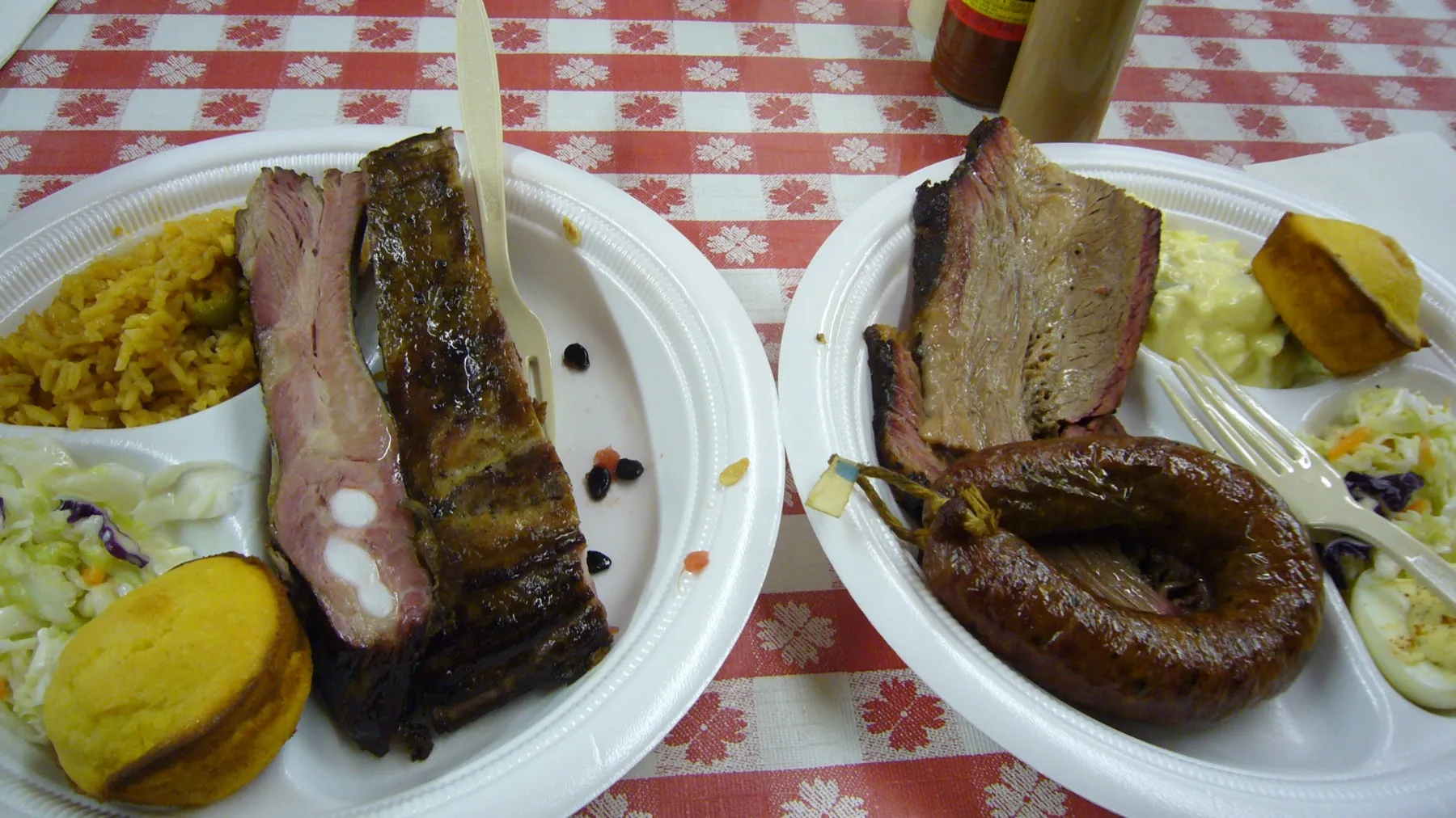 A sliced smoked beef brisket with a fat cap and pink smoke ring