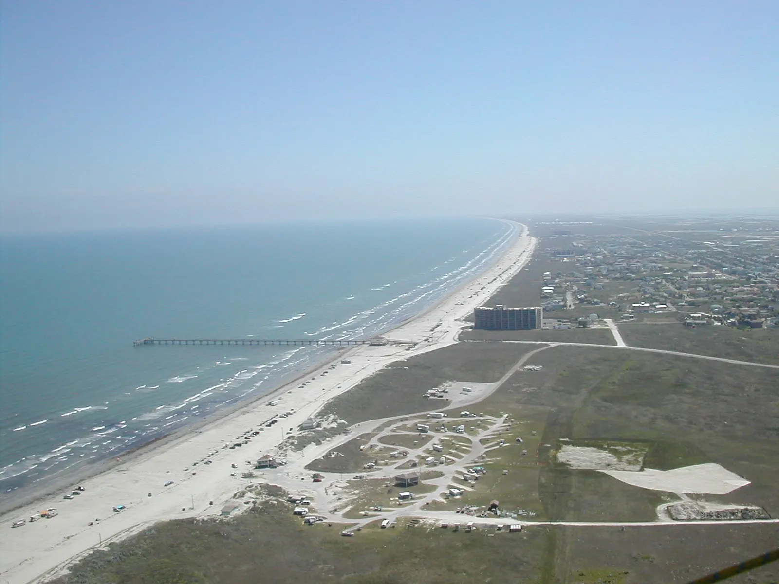 An aerial view along Port Aransas Beach and the developed edge of Mustang Island