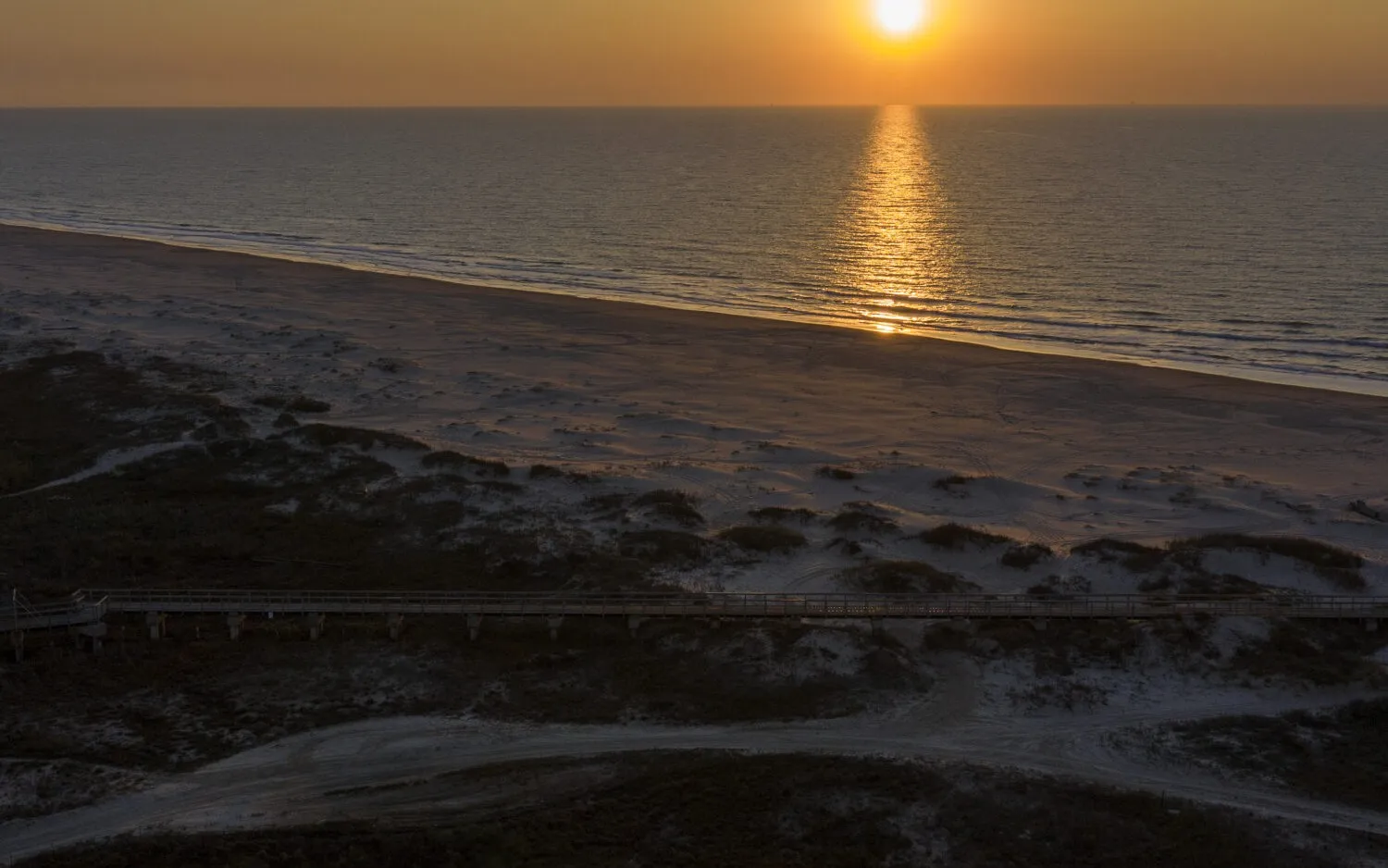 Sunset over the beach and grassy dunes at Matagorda Bay Nature Park