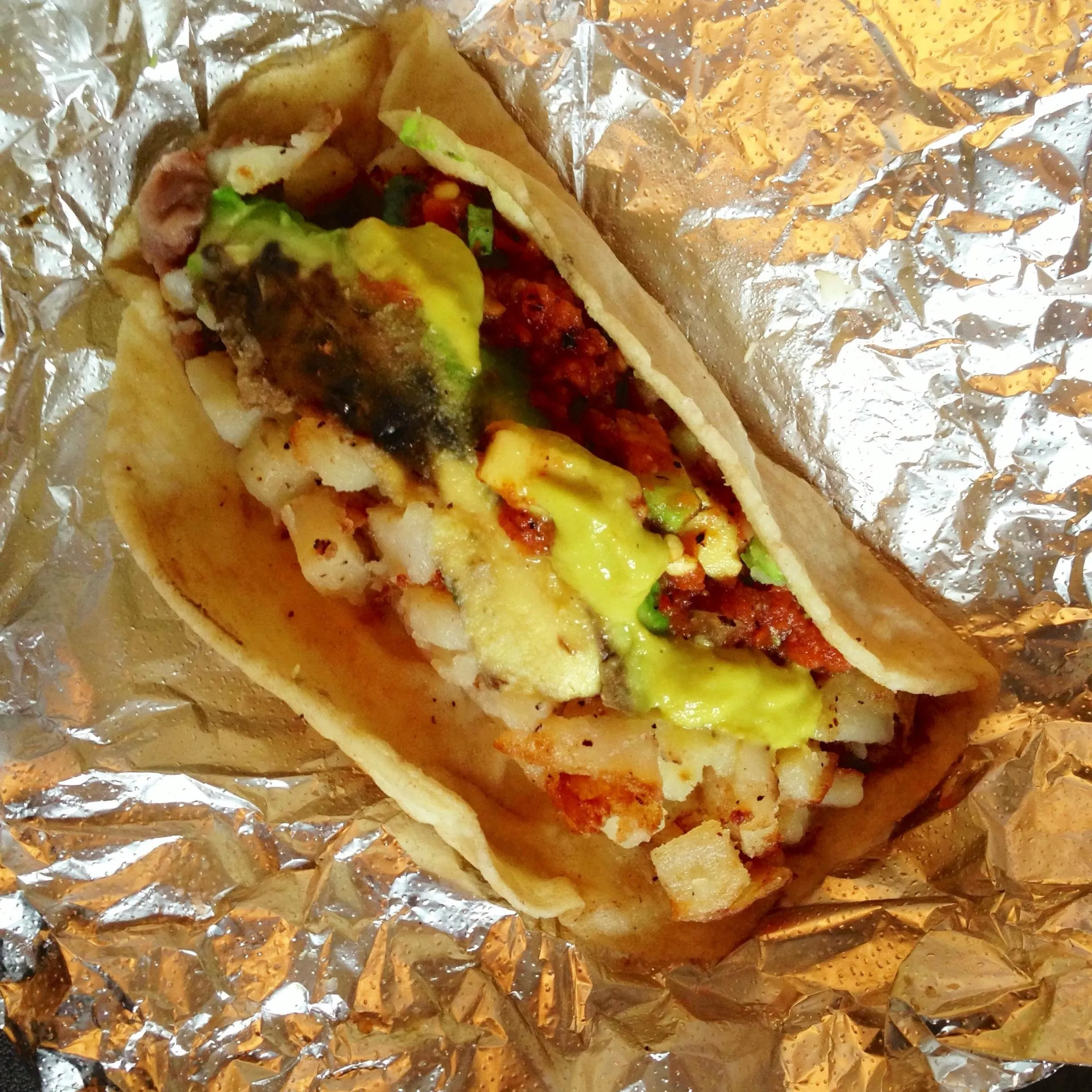 A folded corn tortilla taco filled with vegetables, from Veracruz All Natural in Austin