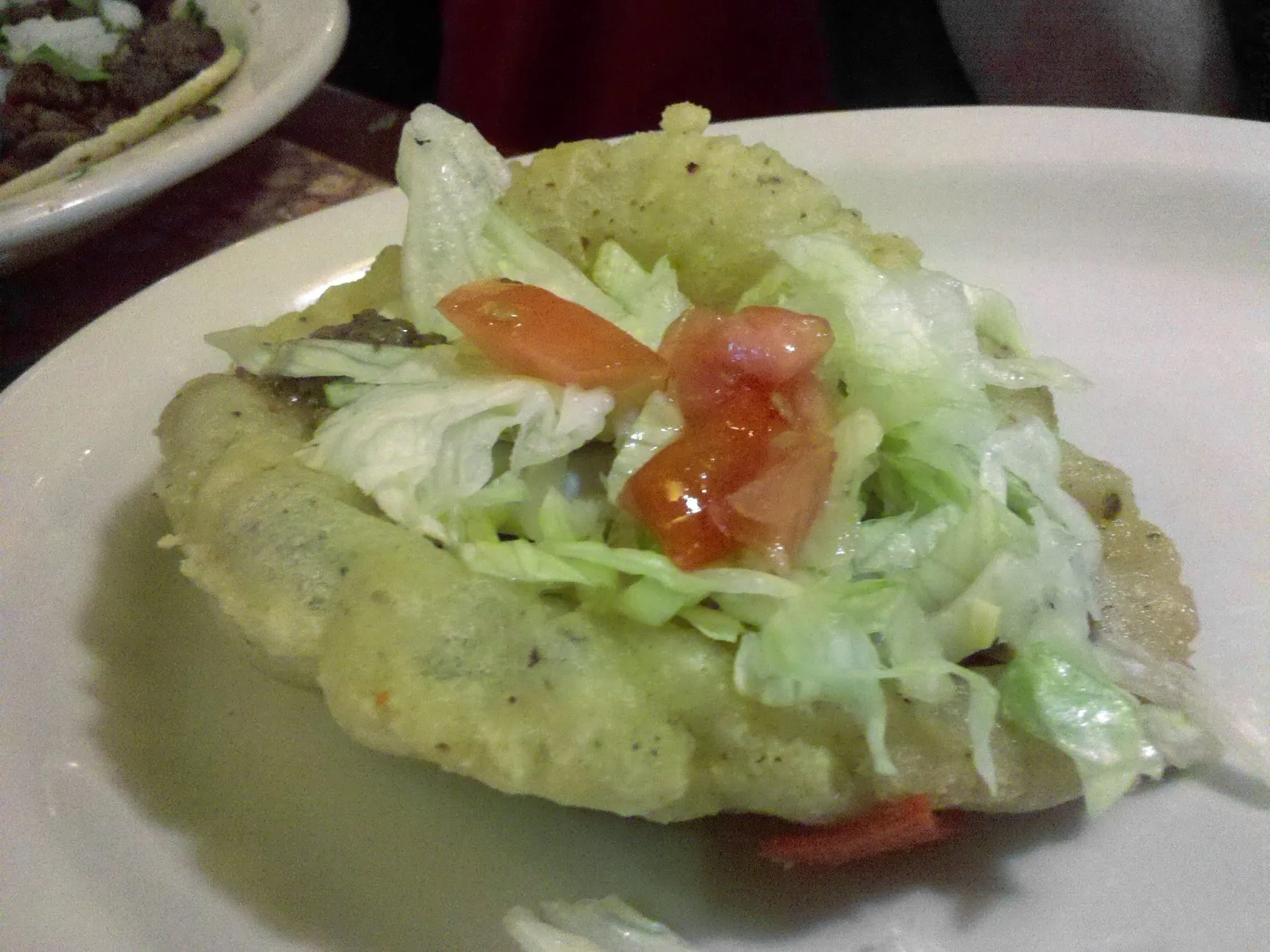A puffy fried-masa taco filled with meat, lettuce and cheese, San Antonio style