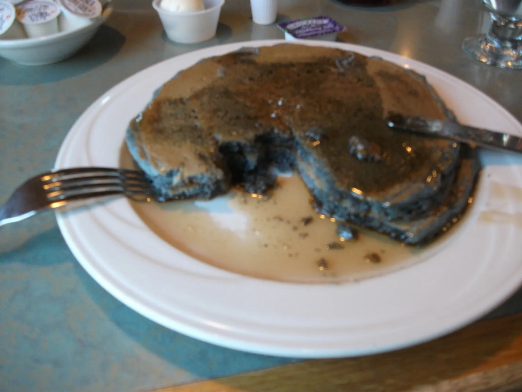 A stack of blue corn pancakes on a plate