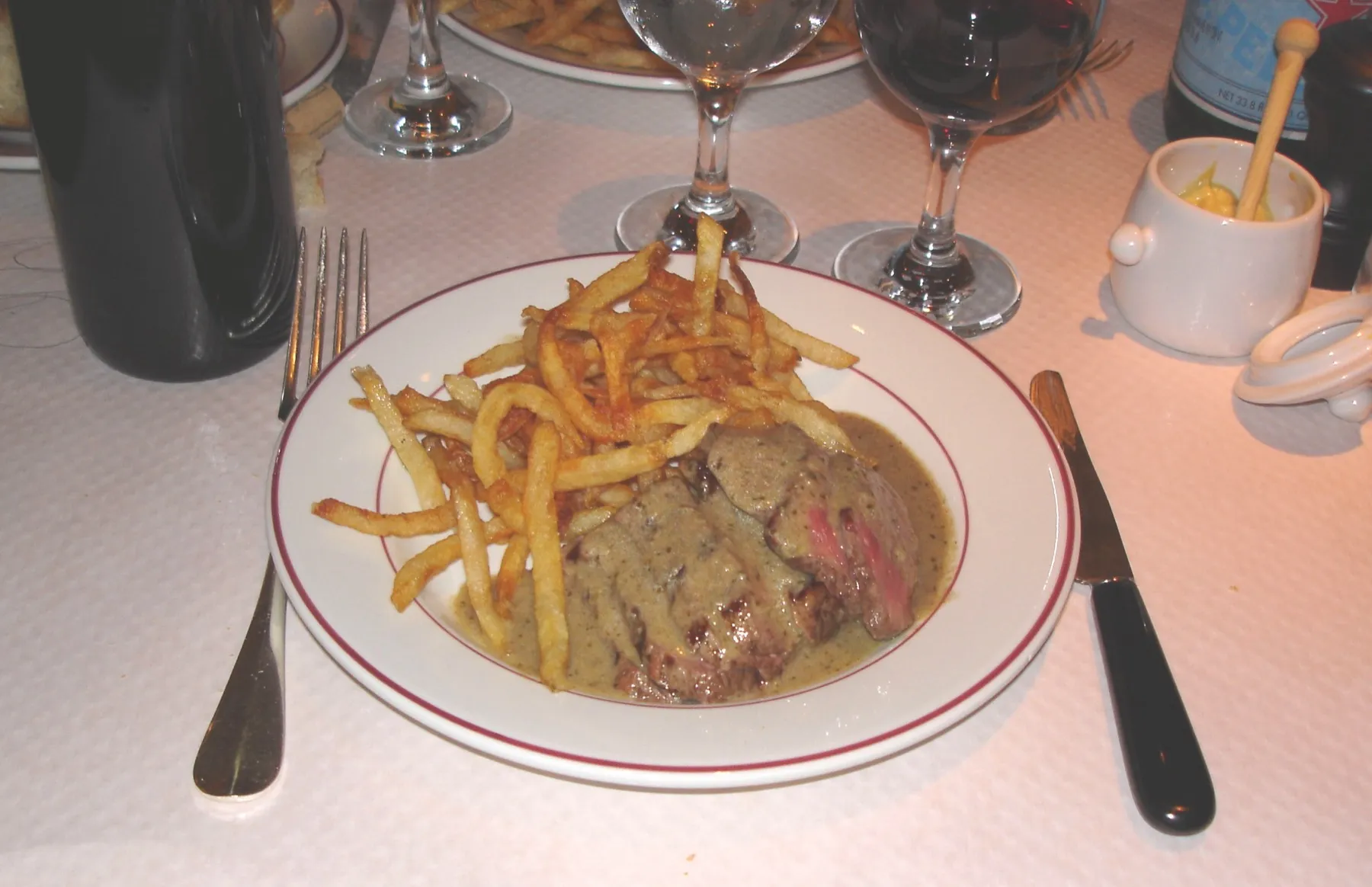A plate of steak frites, steak served with thin fried potatoes