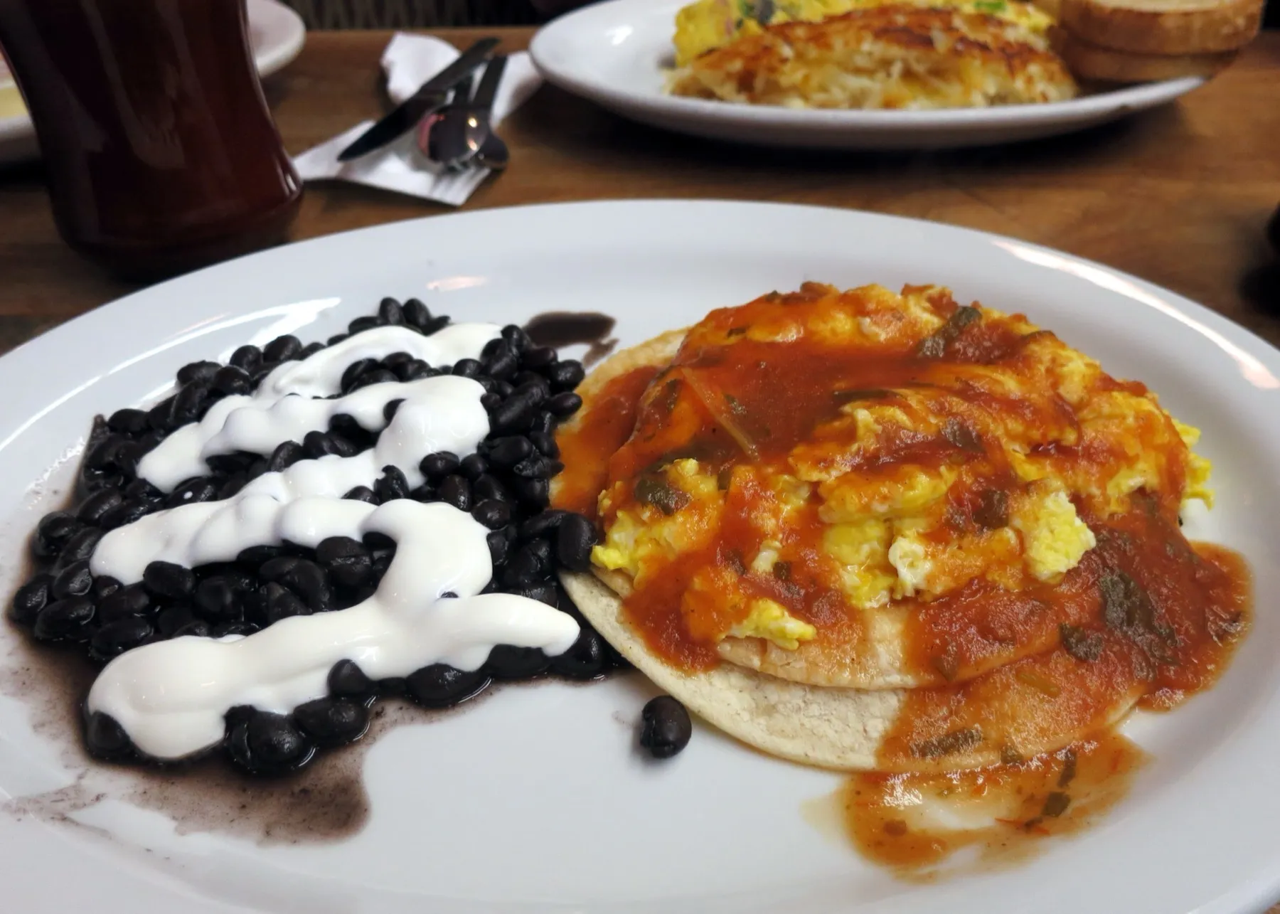 A plate of huevos rancheros with salsa