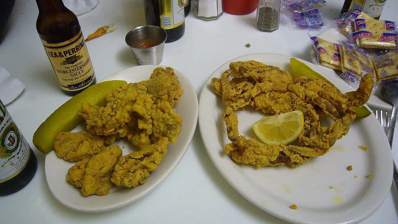 Fried oysters and a fried soft-shell crab arranged on a plate