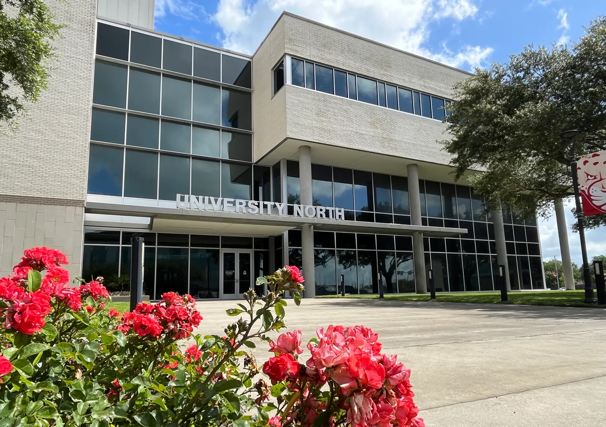 University North at Texas A&M University-Victoria, with red flowers in front