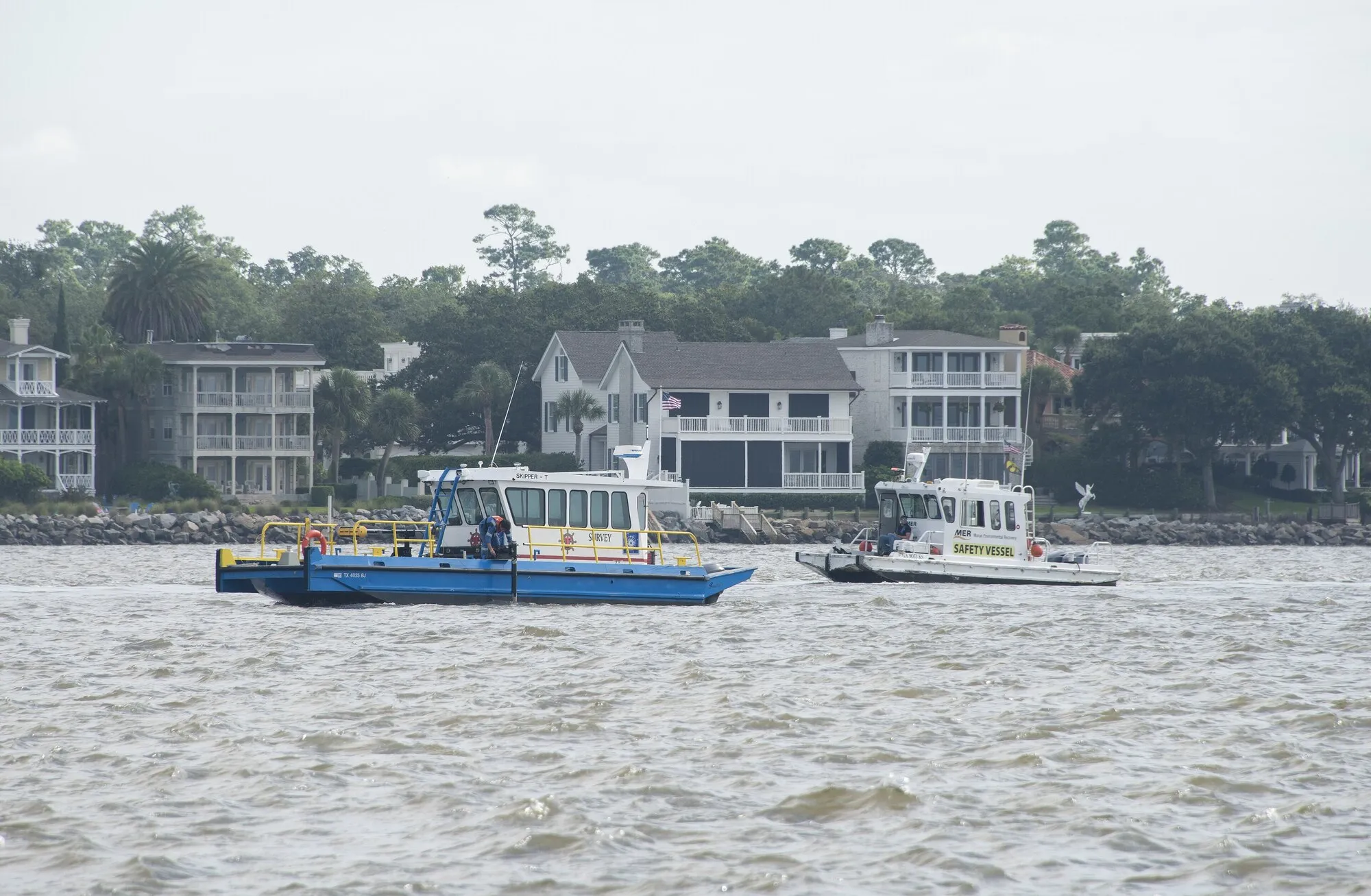 A small survey vessel moving across open water during a hydrographic survey