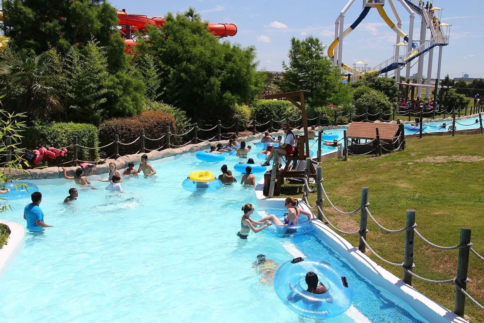 Families floating in the Kona Kooler lazy river at Hawaiian Falls in The Colony