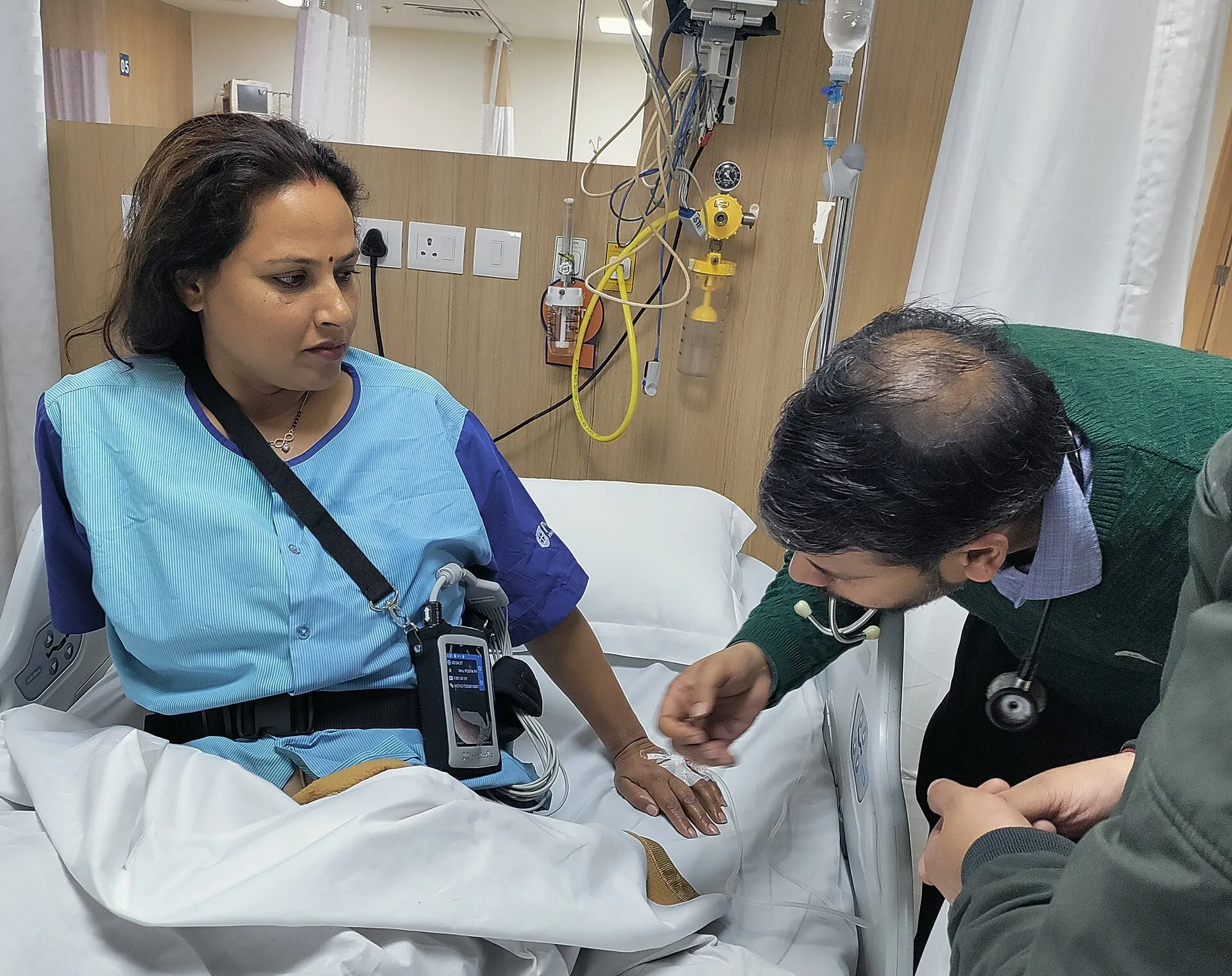 A clinician attaching capsule endoscopy recording equipment to a patient
