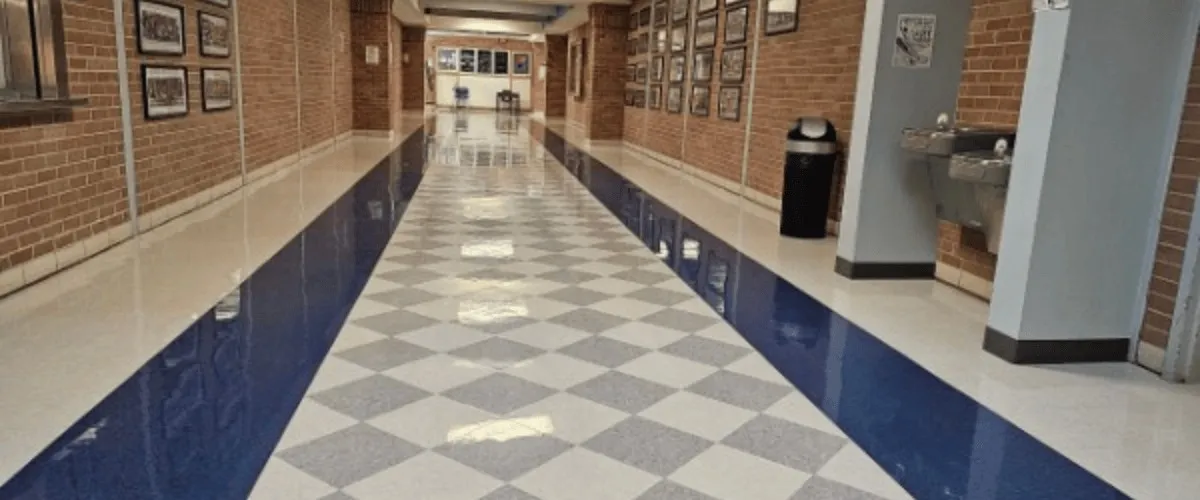 An empty brick-lined hallway with blue and white tile at the Liberal Arts and Science Academy