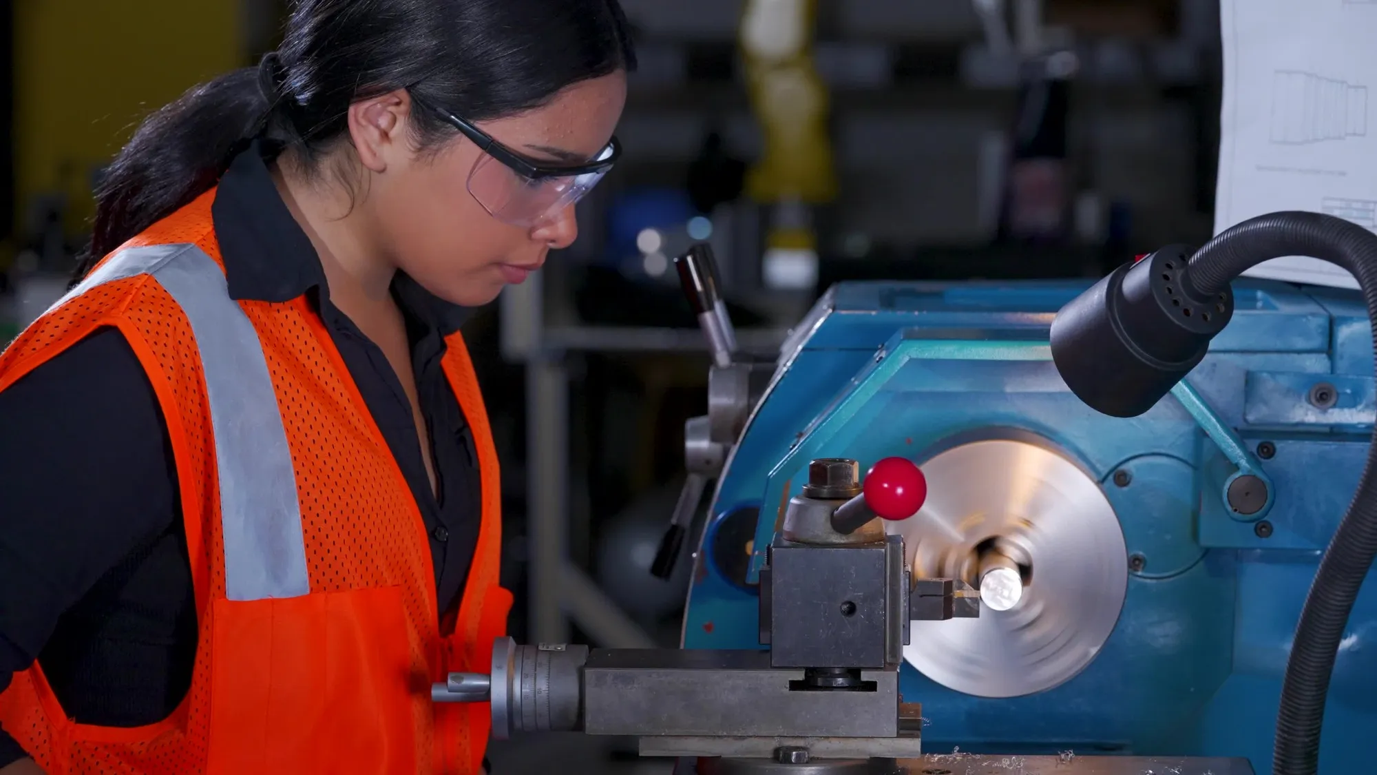 A South Texas ISD Science Academy student wearing safety glasses while operating a metal lathe