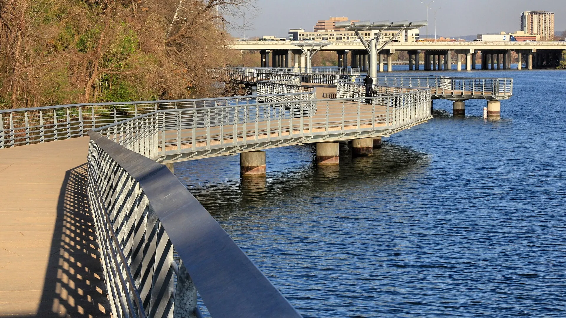 The concrete Butler Hike-and-Bike Trail boardwalk curving over Lady Bird Lake