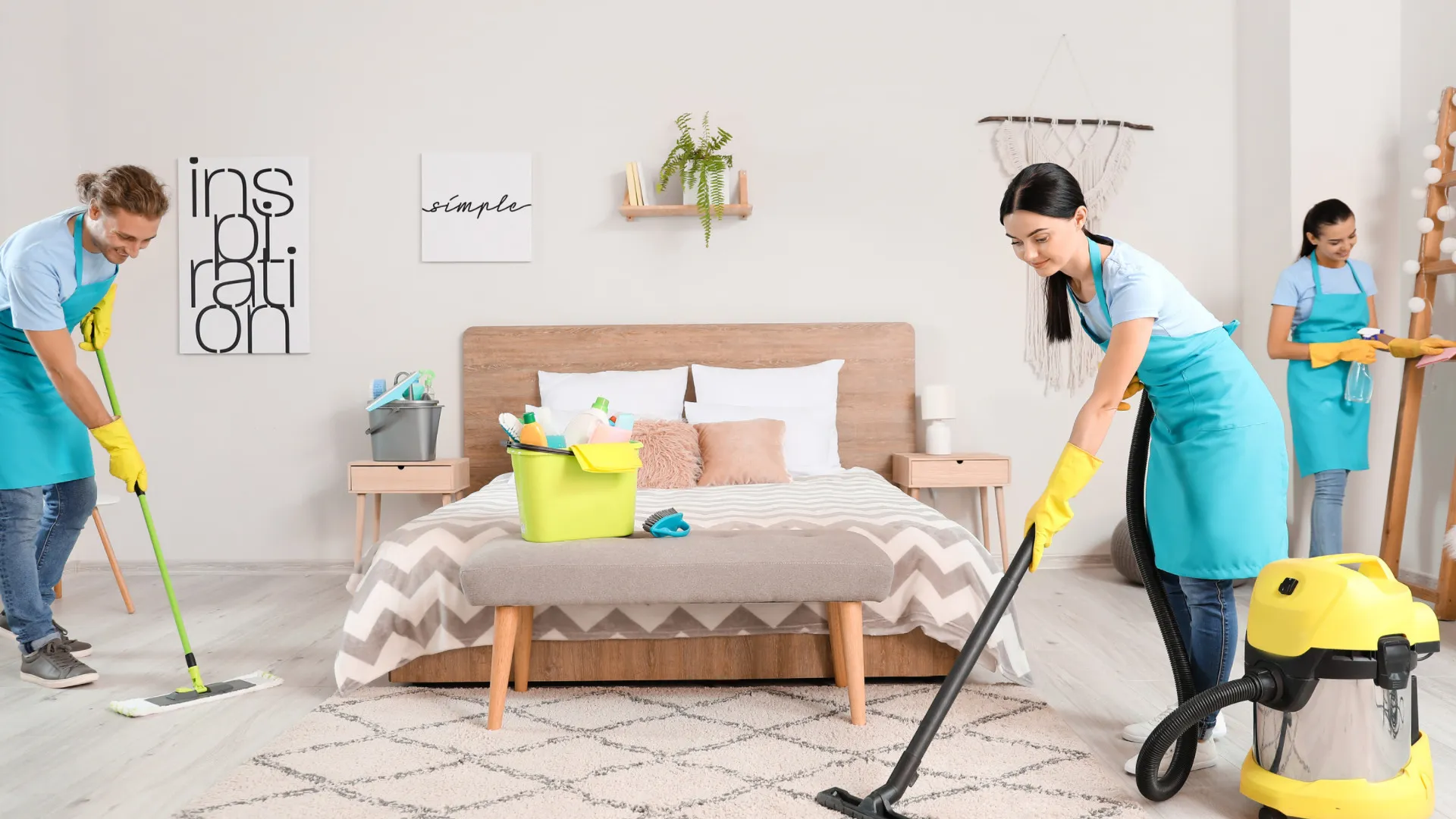 Three cleaners with mops, cloths and a canister vacuum working in a bedroom on Sofy's official website