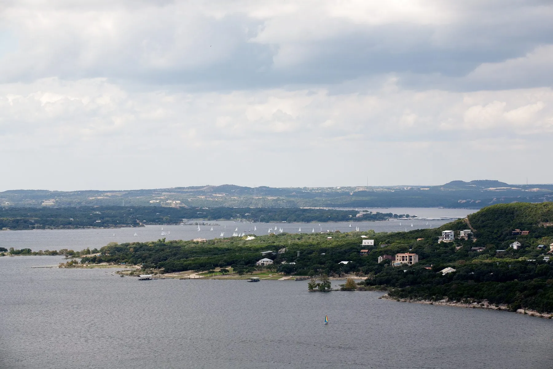 Lake Travis at full capacity, with open water and wooded limestone shoreline
