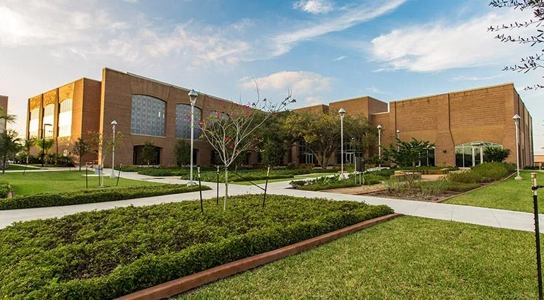 The brick Medical Education Building and landscaped courtyard at UTRGV in Edinburg