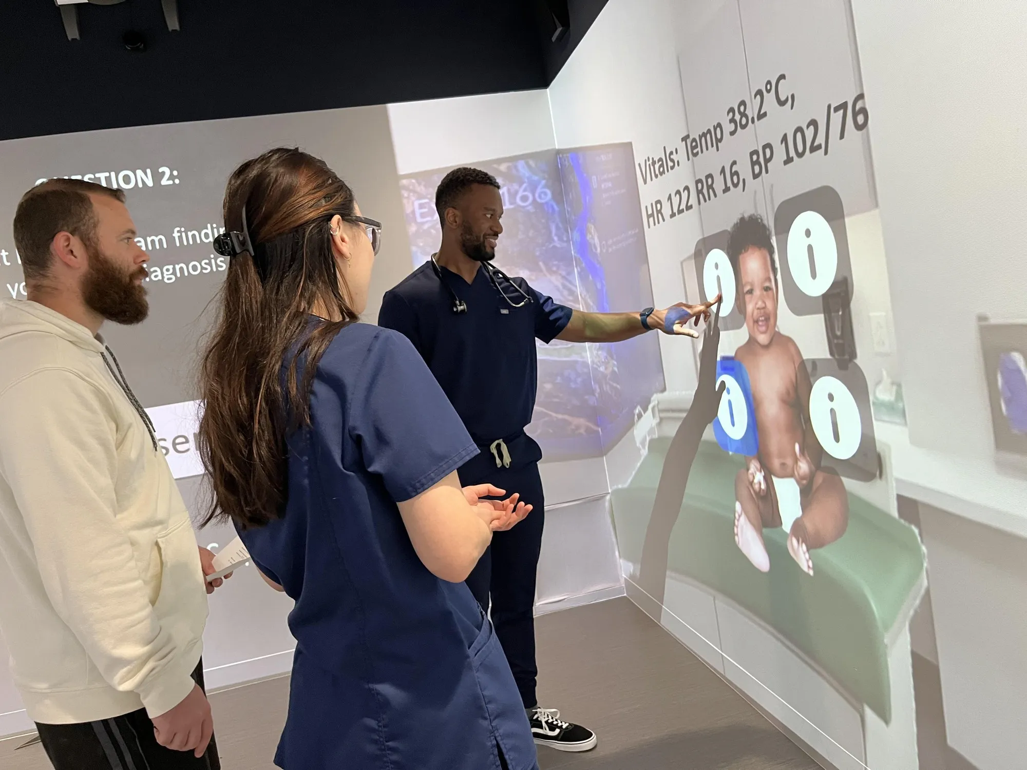 Texas College of Osteopathic Medicine students in scrubs working through a pediatric simulation