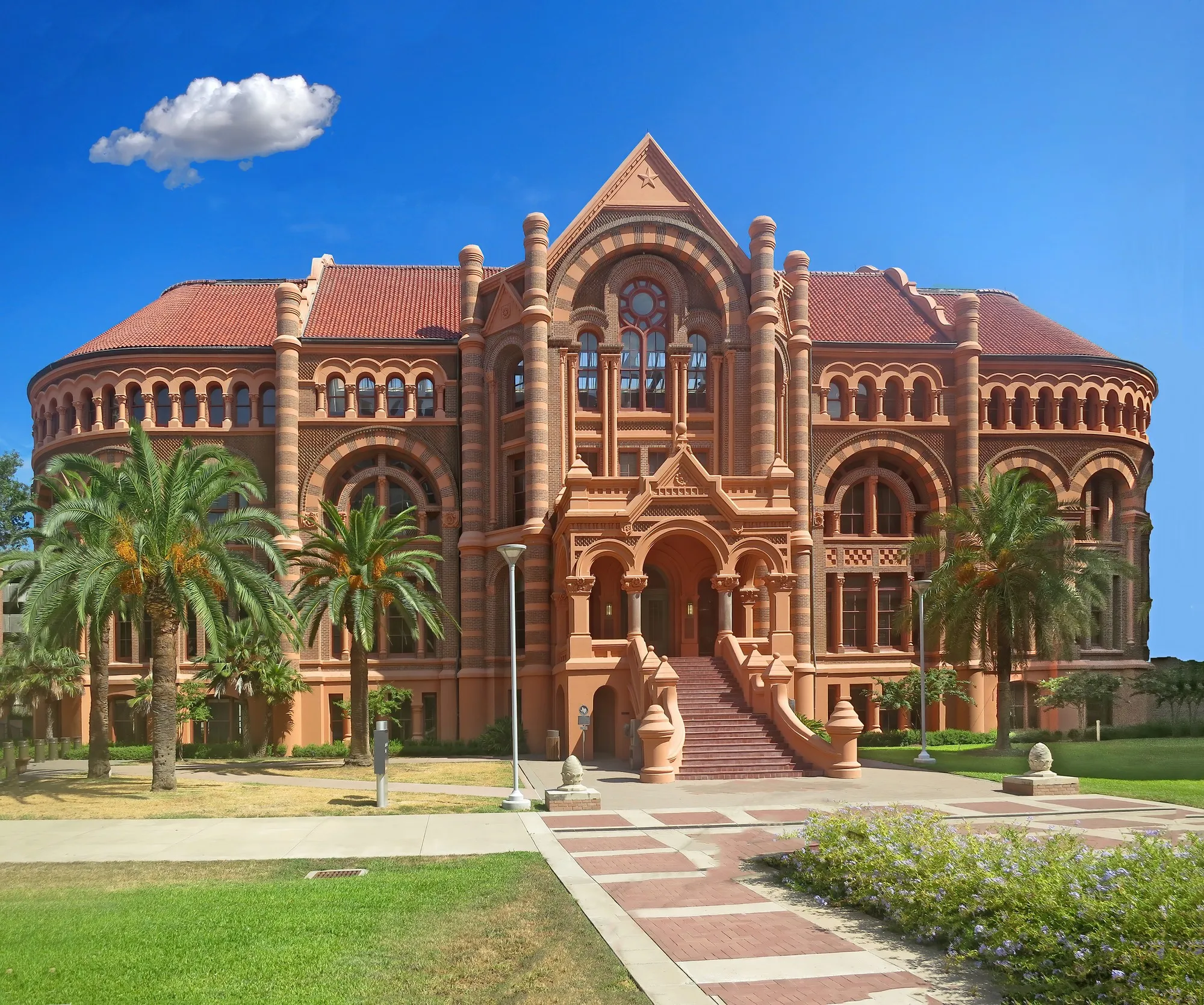The red sandstone Romanesque facade of the Ashbel Smith Building on the UTMB campus in Galveston