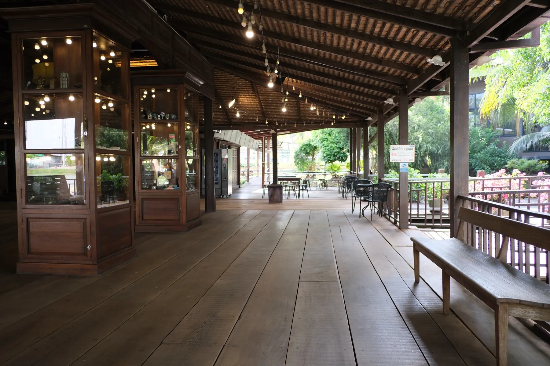 A covered outdoor dining patio with wood beams