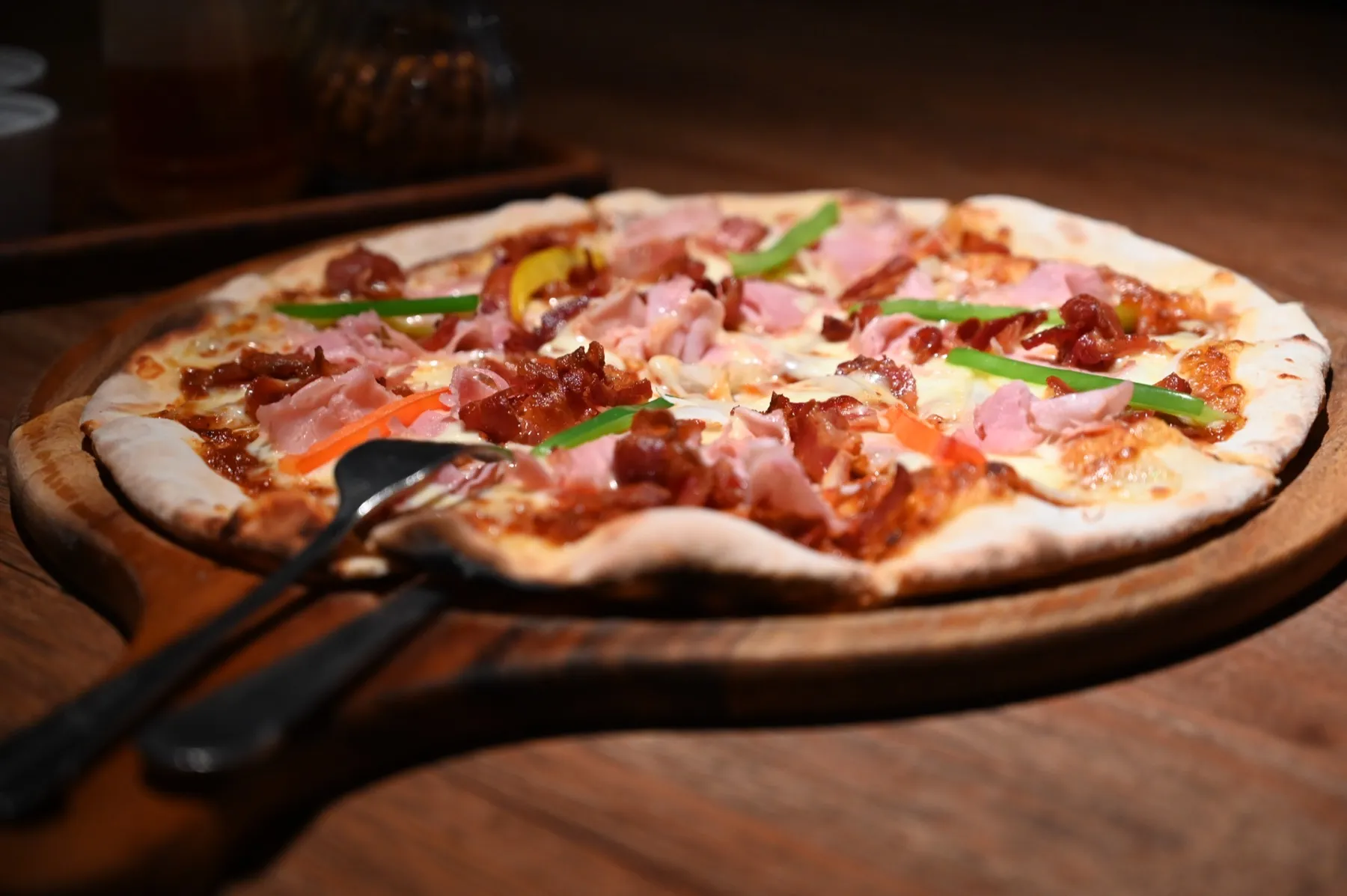 A wood-fired pizza served on a wooden board