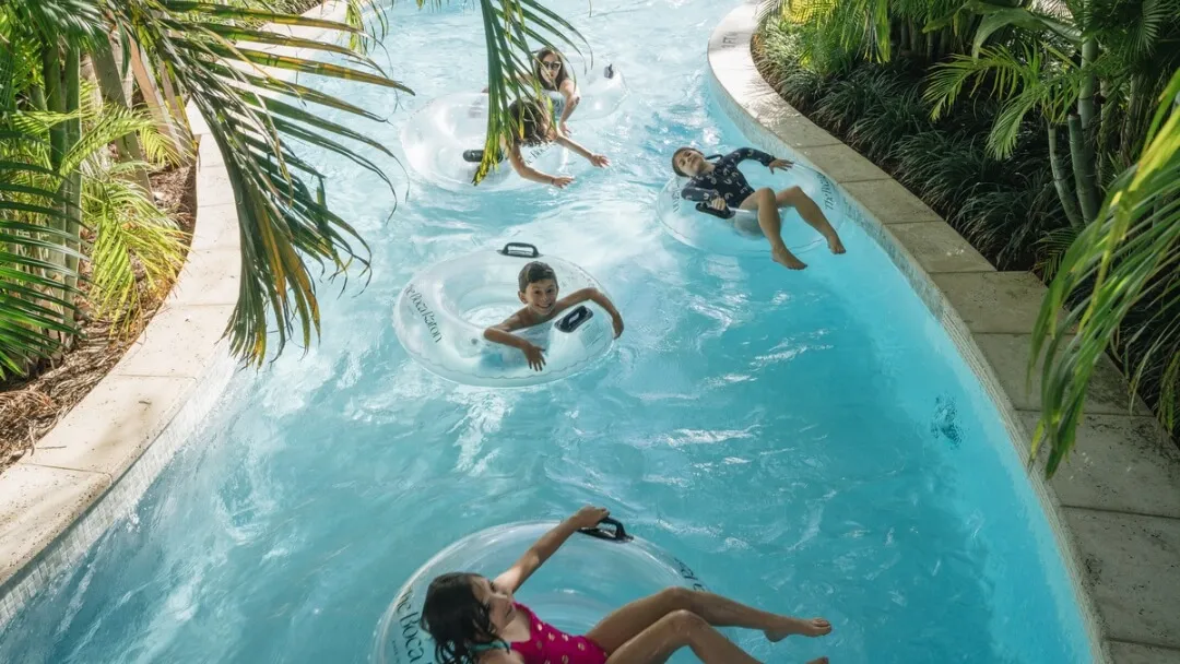 A lazy river winding through a resort pool complex