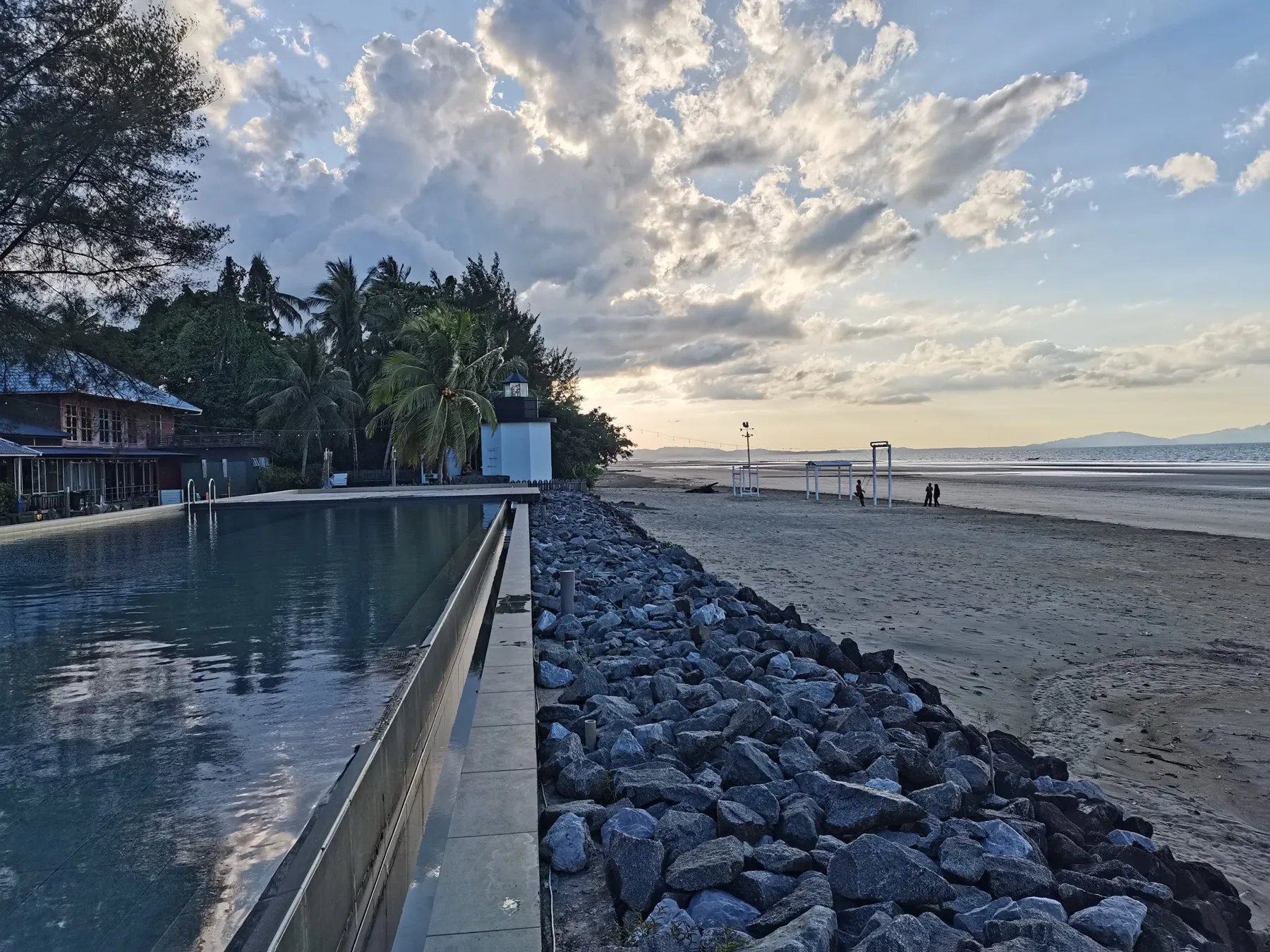 A resort swimming pool lined with palms