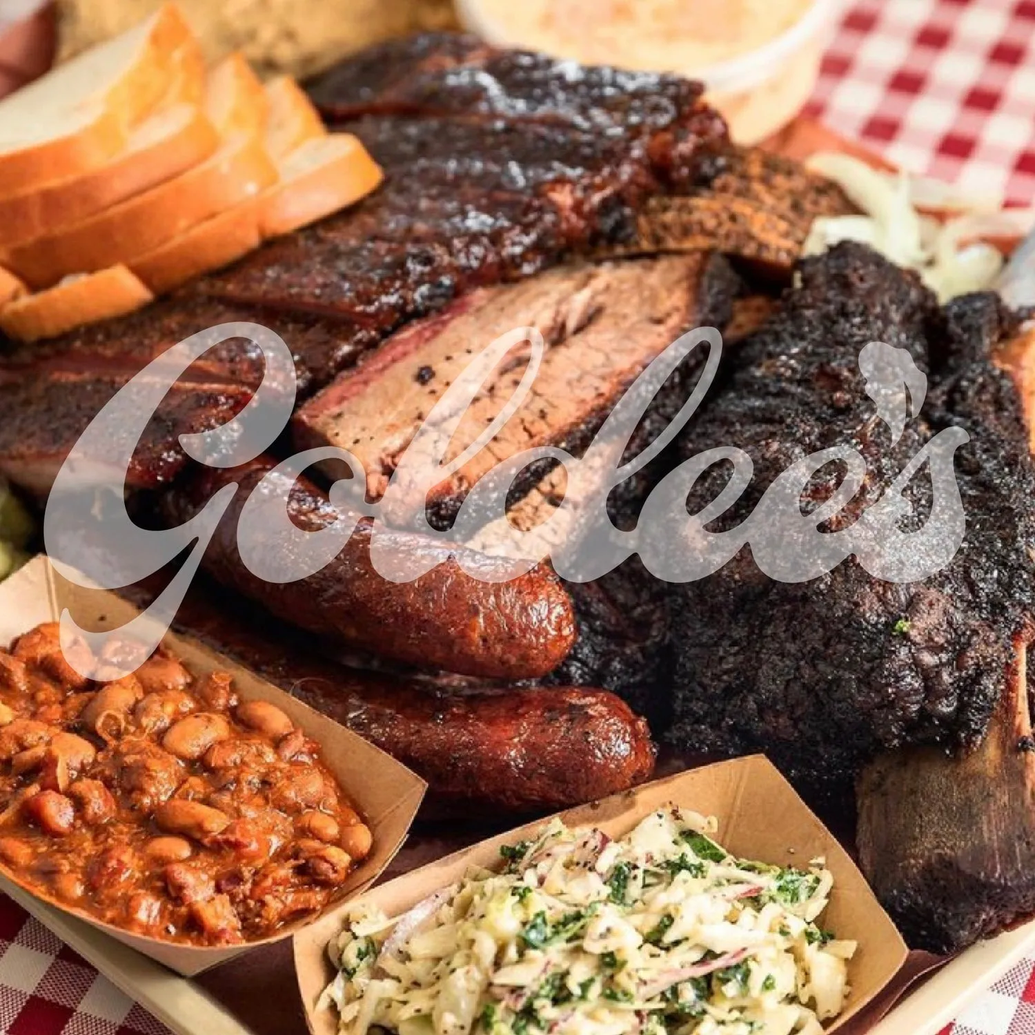 A Goldee's Barbecue tray with sliced brisket, pork ribs, sausage, bread, beans, and slaw