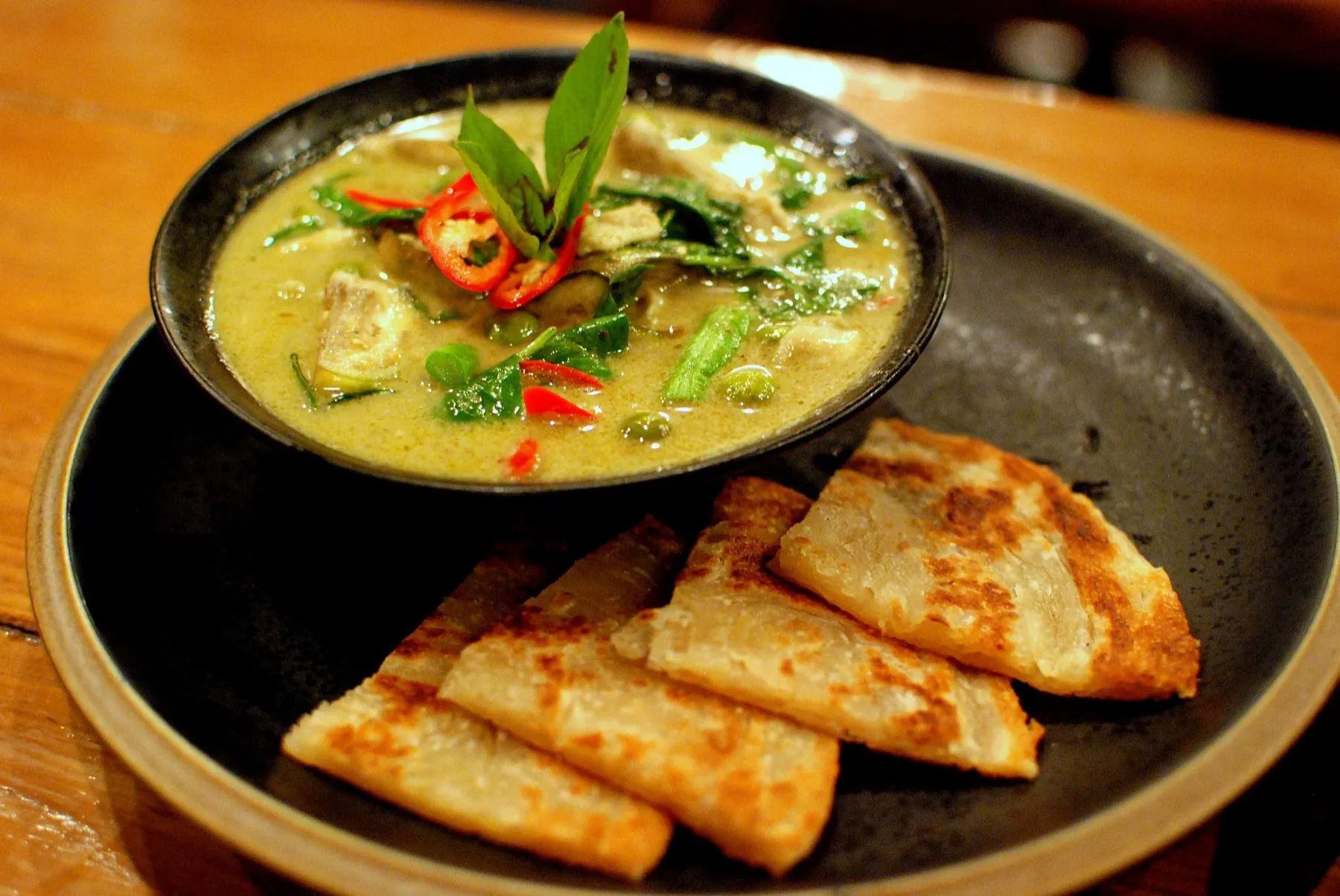 A bowl of Thai green curry with chicken
