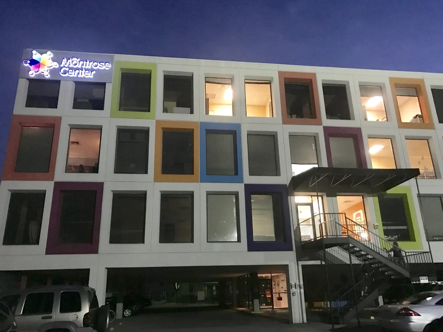 The Montrose Center building lit up at night in Houston