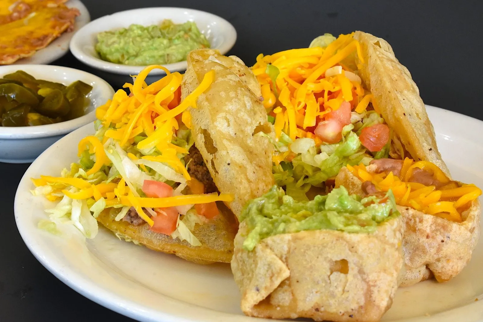 Two puffy tacos and a fried masa bean cup at Teka Molino