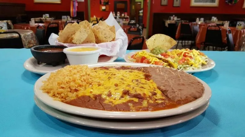 Cheese enchiladas under chili gravy with rice and refried beans at Blanco Cafe