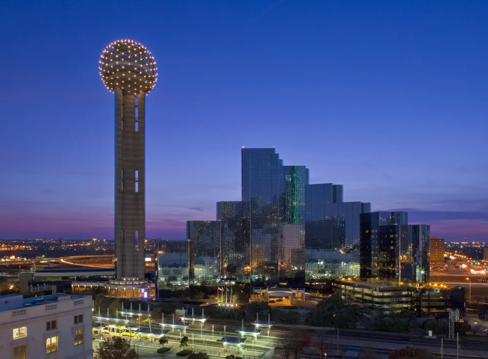 The lit sphere of Reunion Tower against the downtown Dallas skyline
