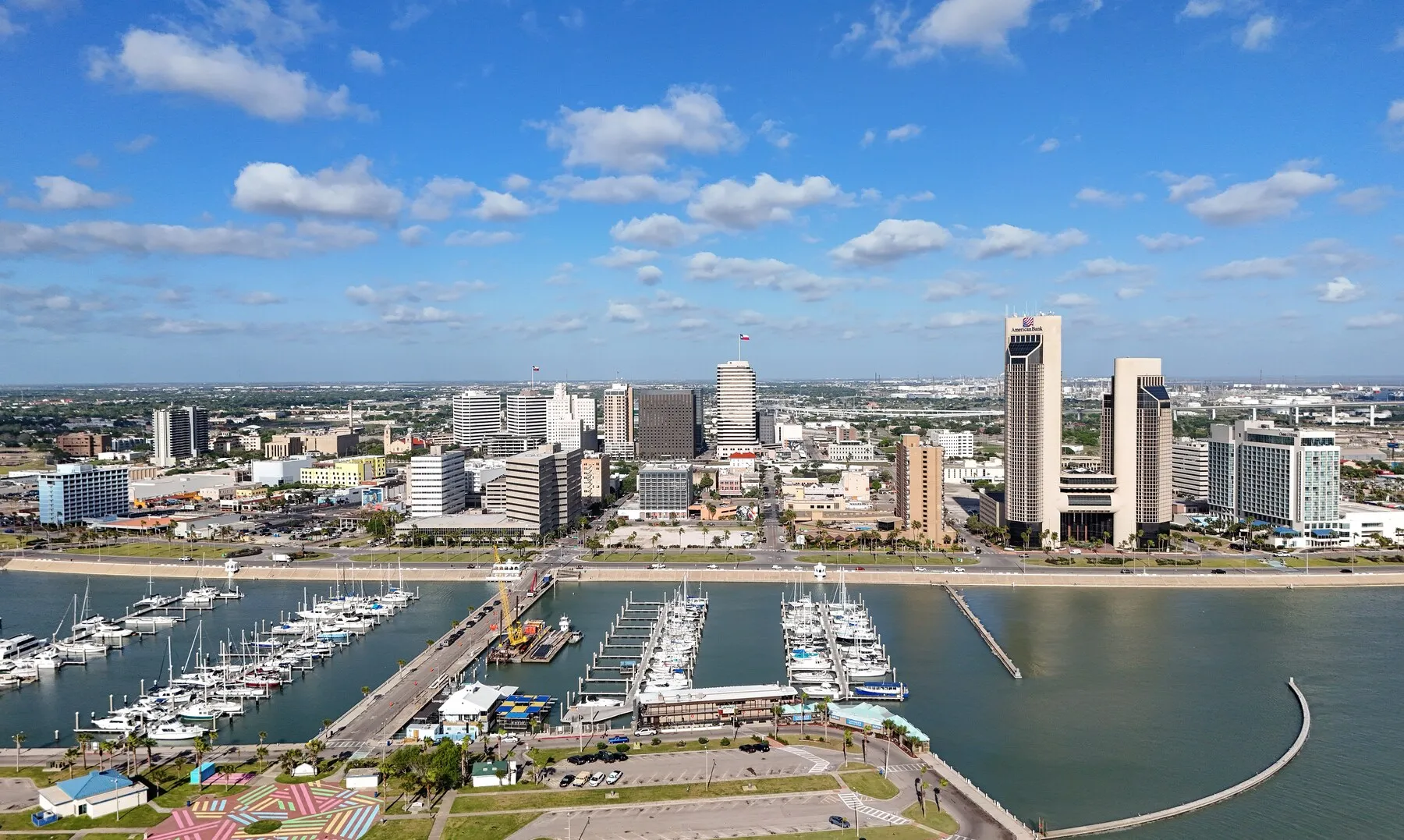 Downtown Corpus Christi and its marina seen from above under a blue sky