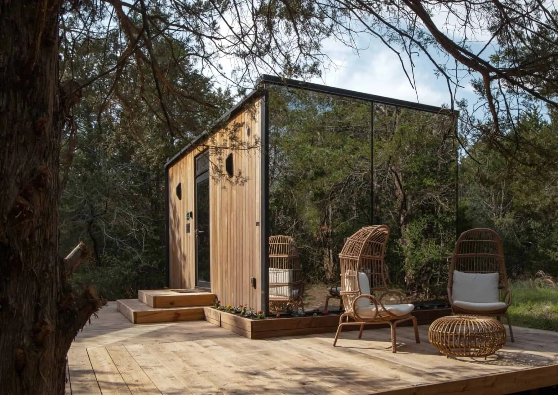 A mirror house and deck among trees at Cameron Ranch Glamping