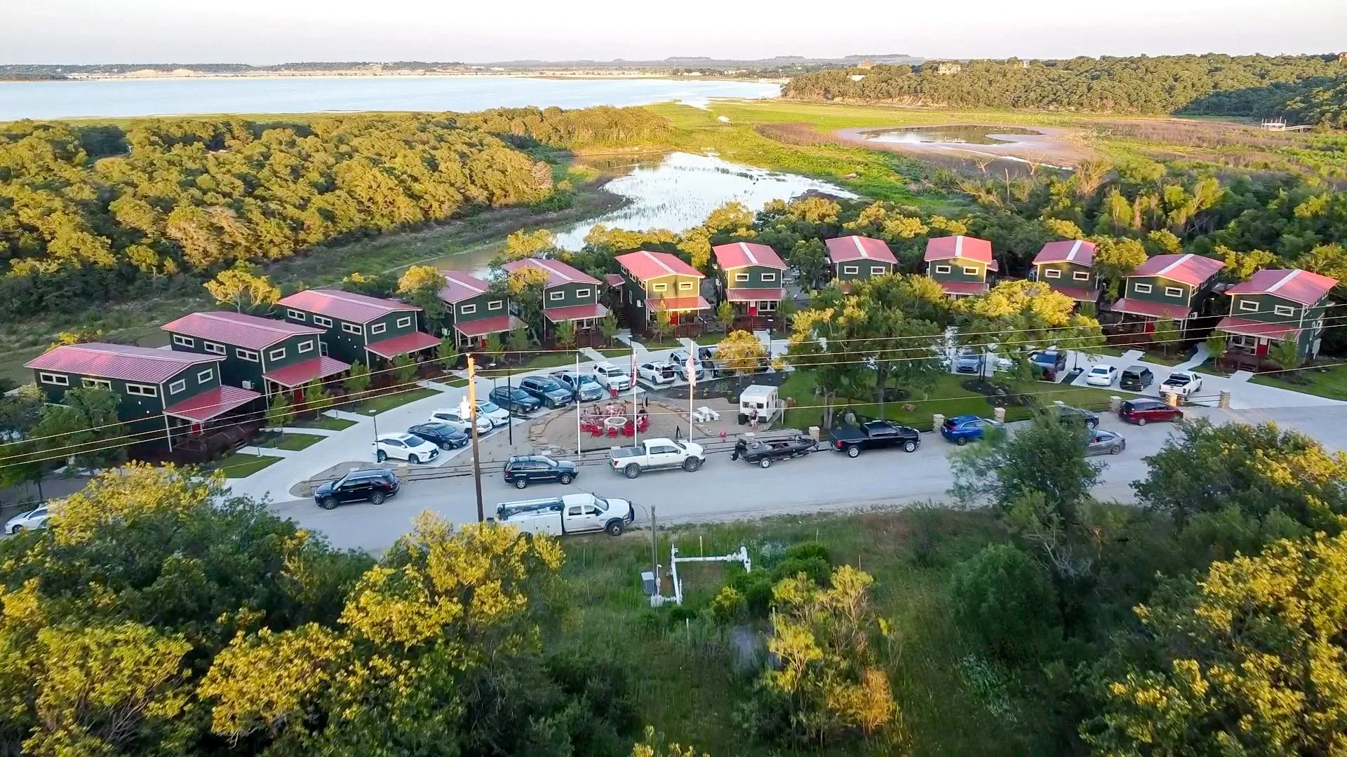 Aerial view of cabins, RV sites and water at CampQYB