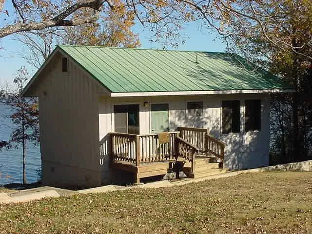 Cabin with a wooden deck overlooking Cooper Lake