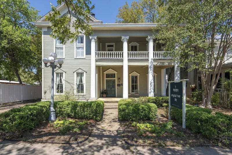 Two-story house with front porch at Crystal River Inn in San Marcos