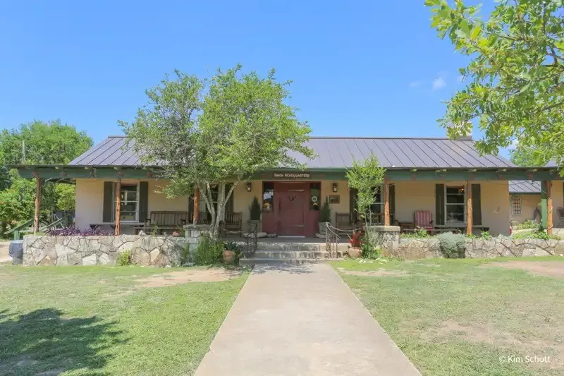 Stone lodge and lawn at Dixie Dude Ranch in Bandera