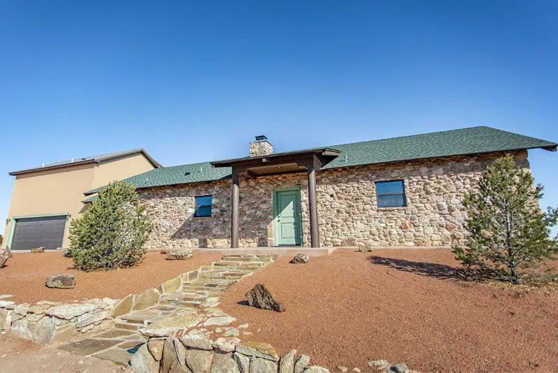 Stone cabin and desert landscaping at Doves Rest Cabins