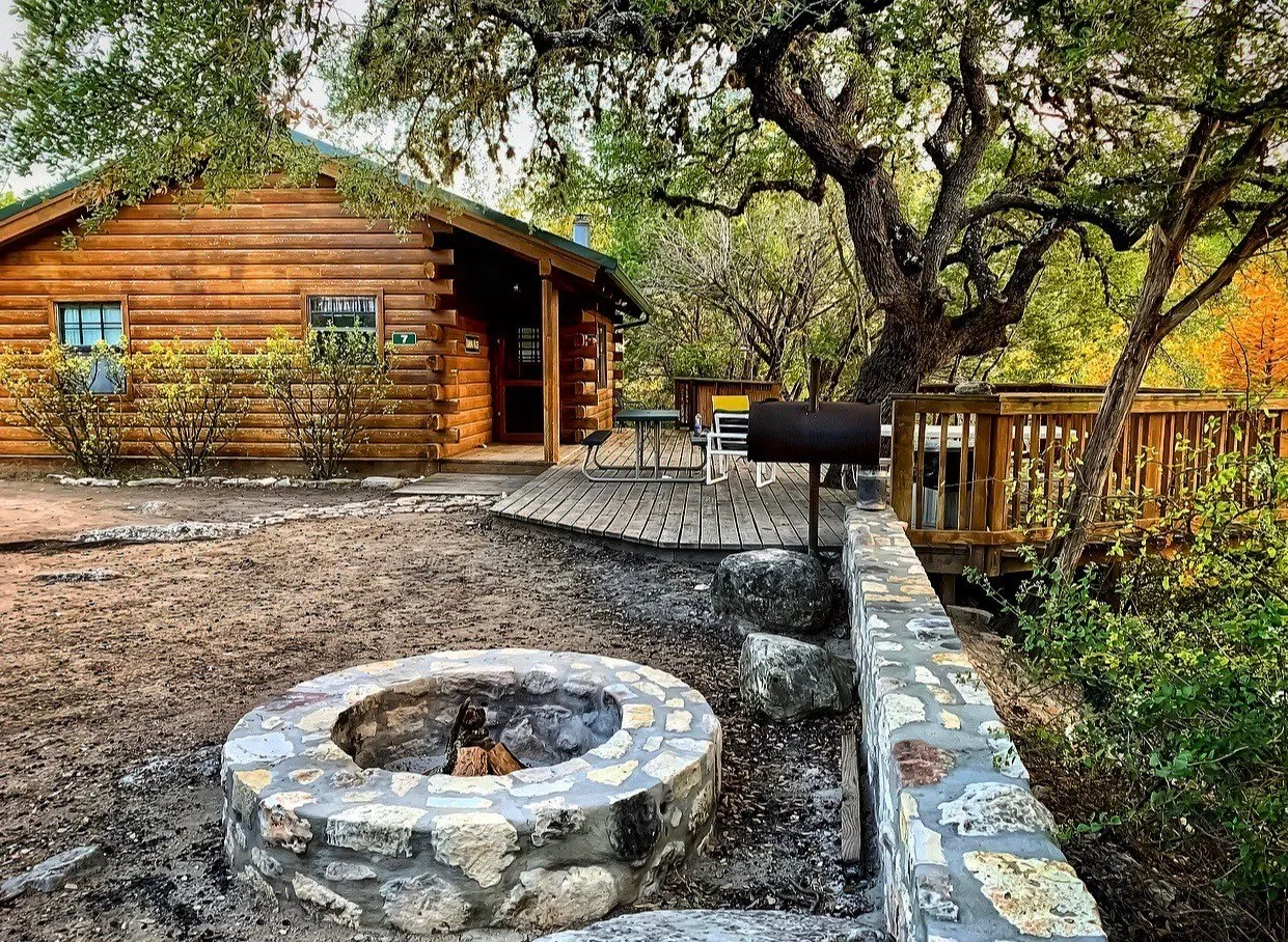 Cabin porch and stone fire pit at Foxfire Cabins