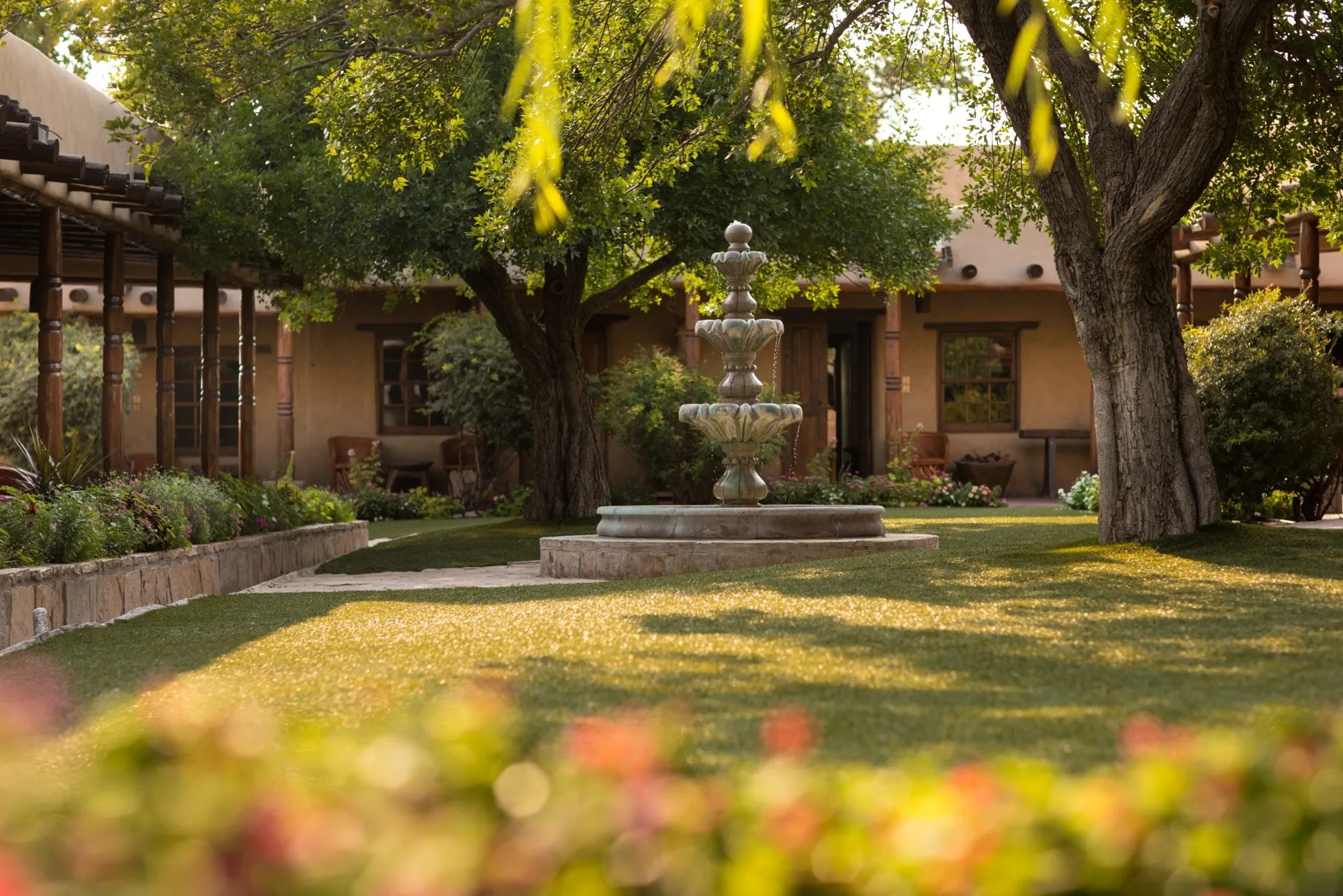 Shaded courtyard with a fountain at the Gage Hotel