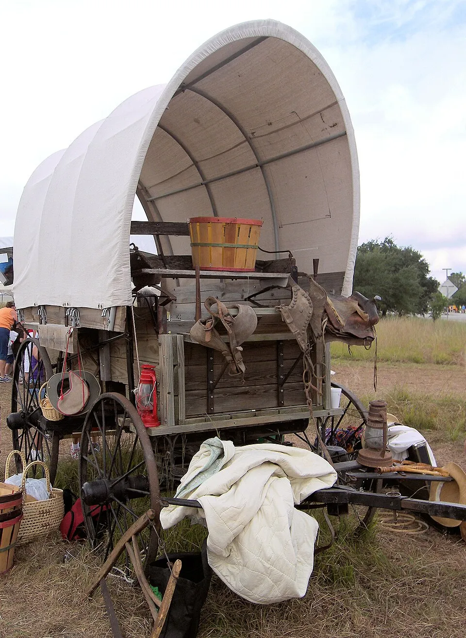 A canvas-covered wagon displayed outdoors in Austin