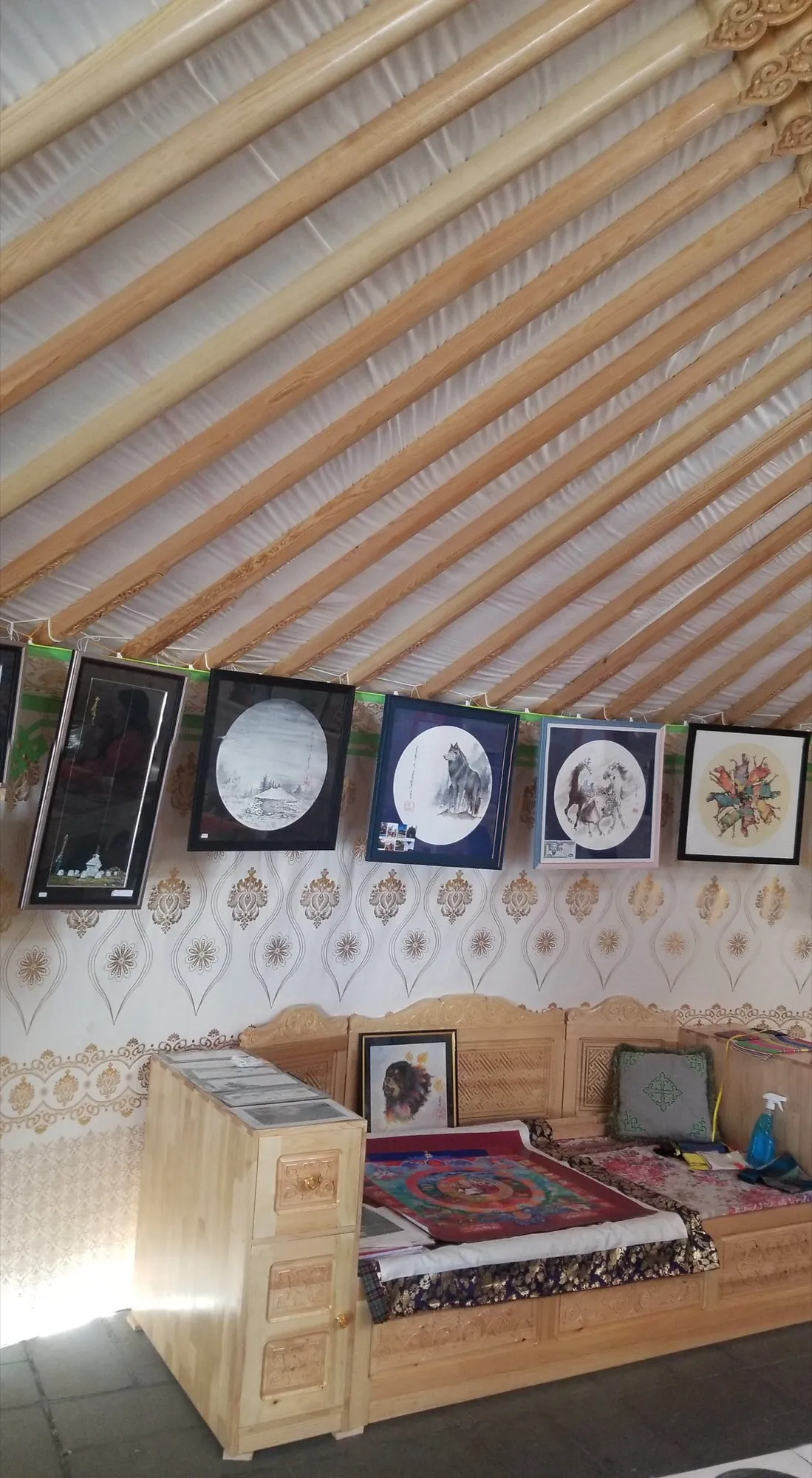 The colorful wood lattice and furnishings inside a Mongolian yurt