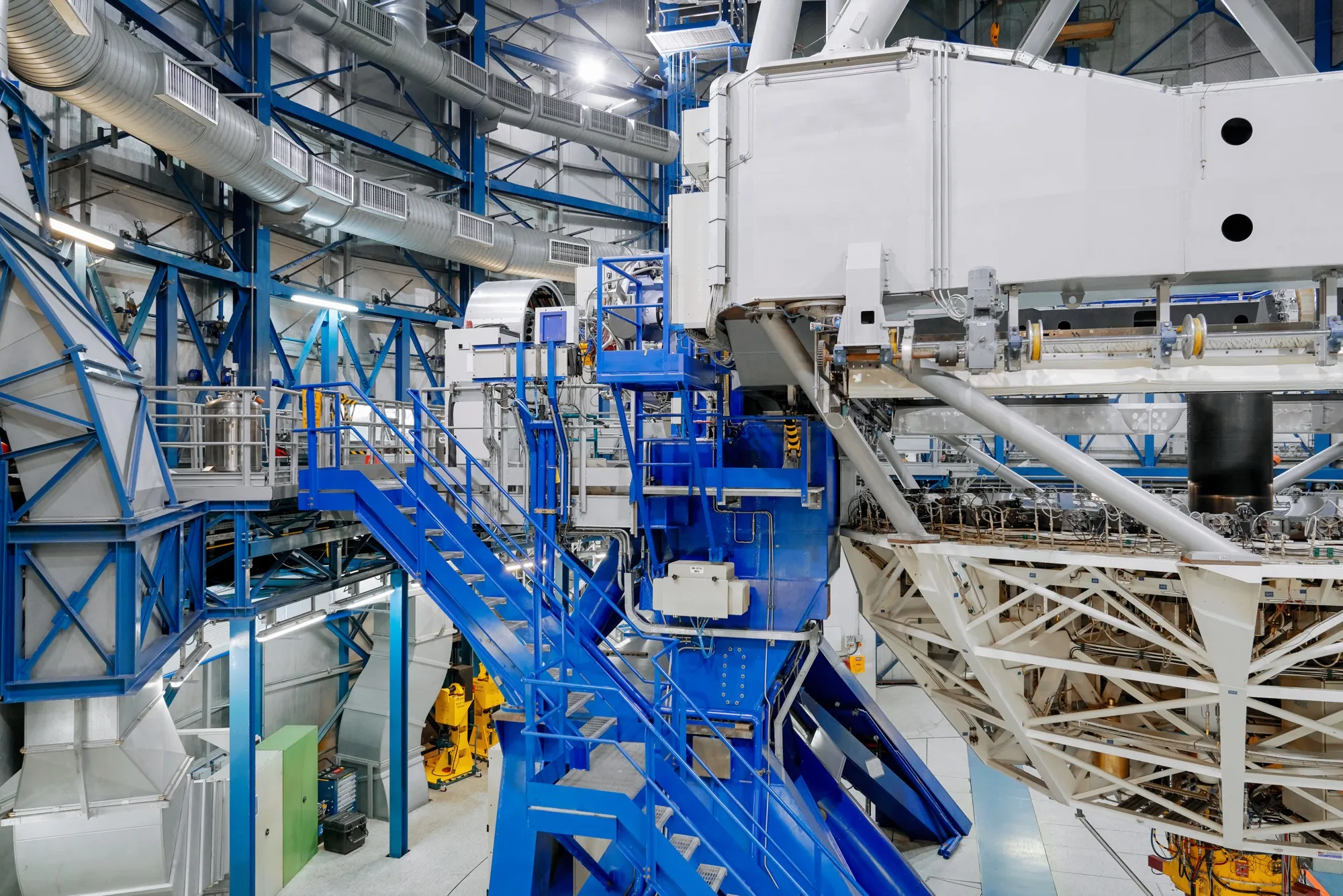 A large telescope and machinery inside an observatory dome