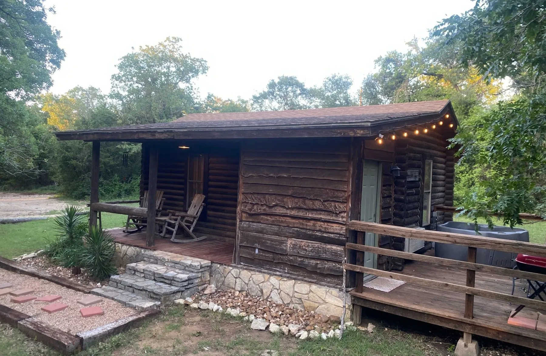 Log cabin with rocking chairs on its porch at Hideaway Ranch and Refuge