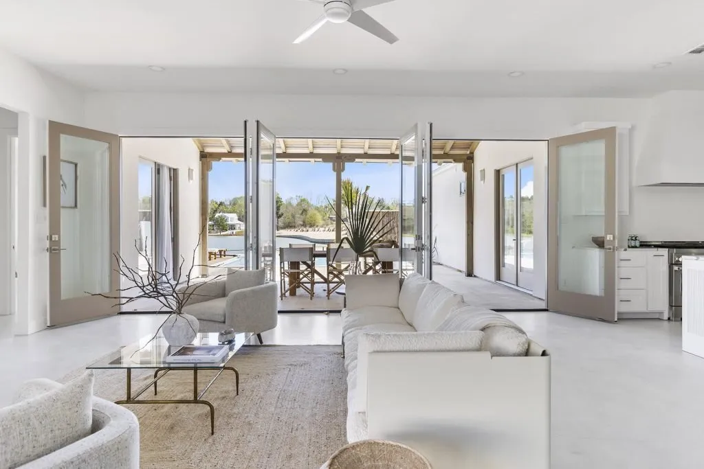White bungalow interior with open doors facing a patio at High Hill Resort