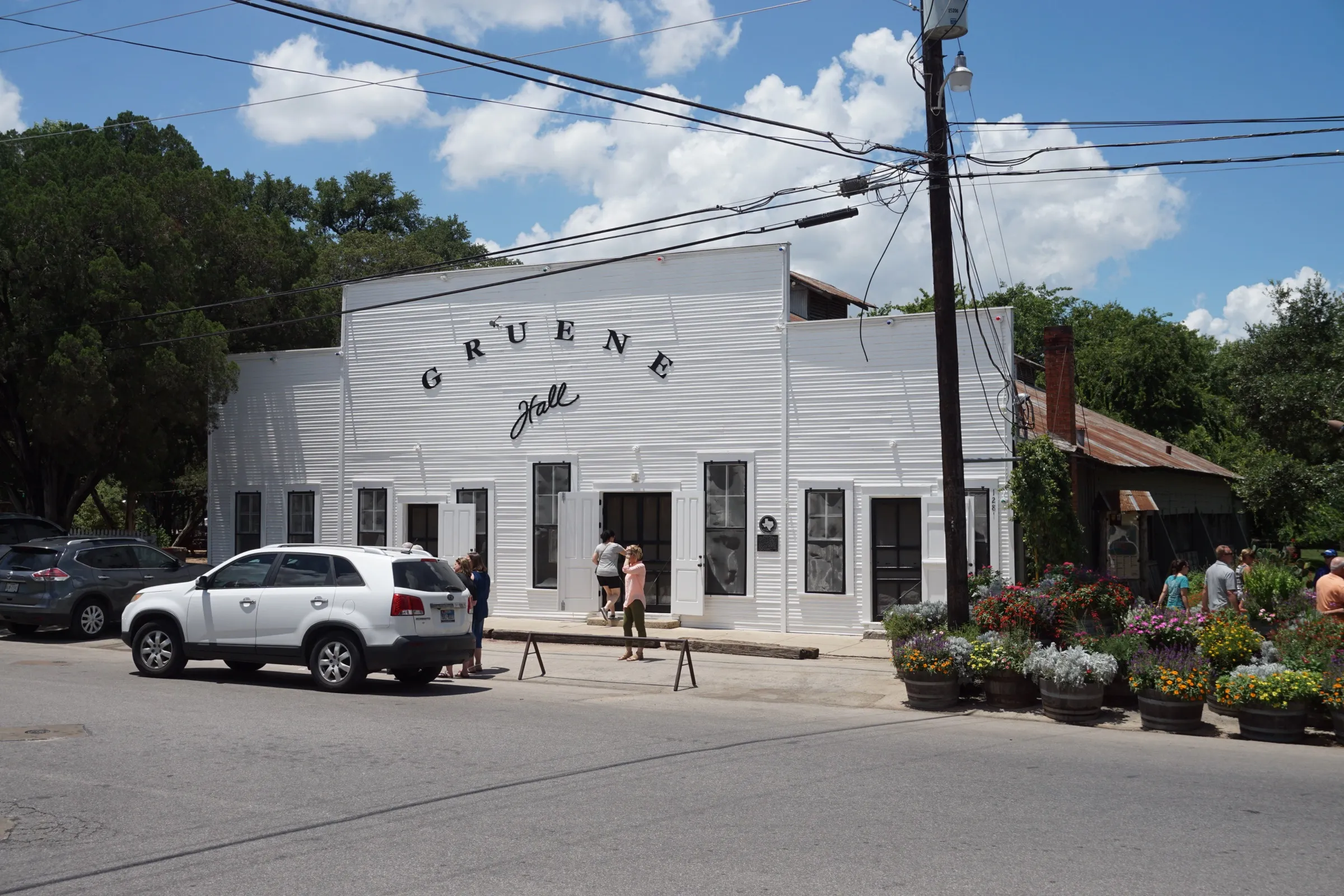 The white clapboard exterior of Gruene Hall, a long single-storey dance hall built in 1878 in New Braunfels